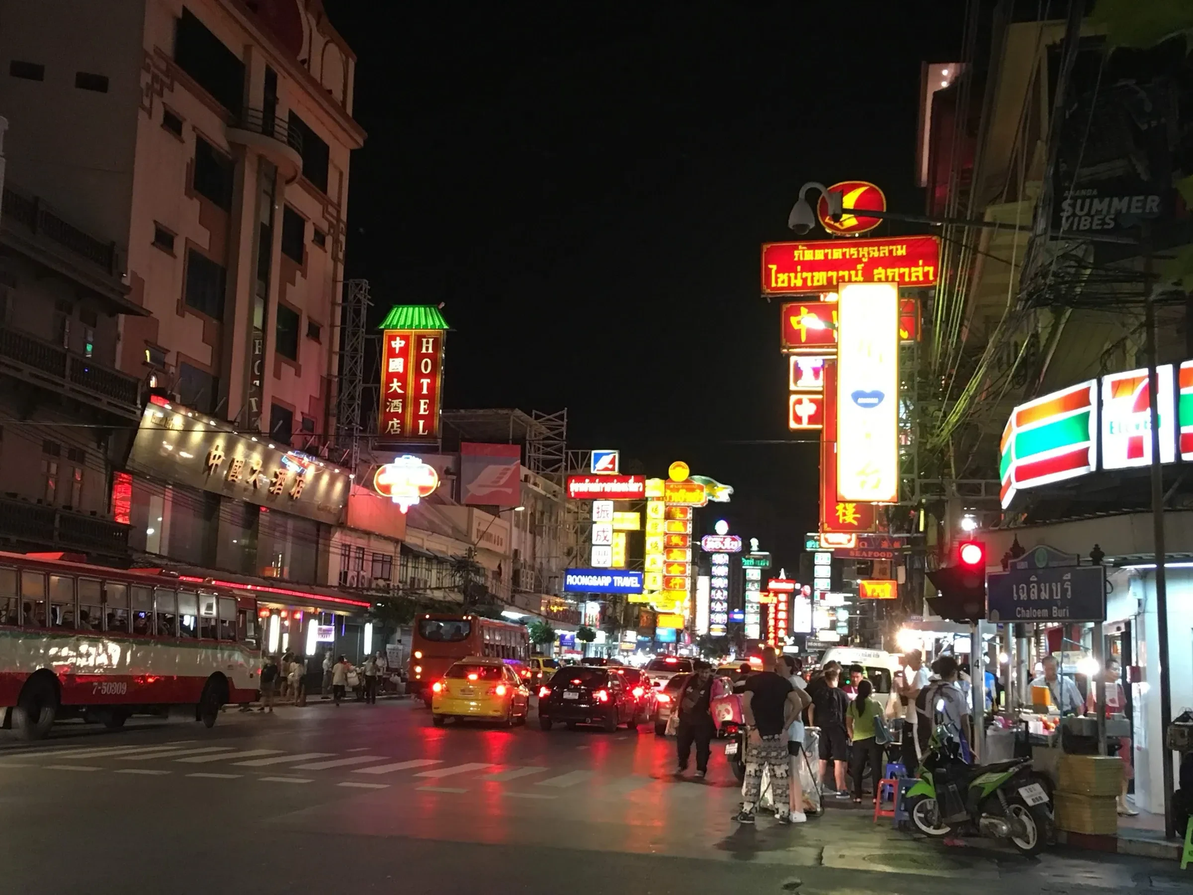 Yaowarat Road in Bangkok's Chinatown at night, with neon signs and traffic