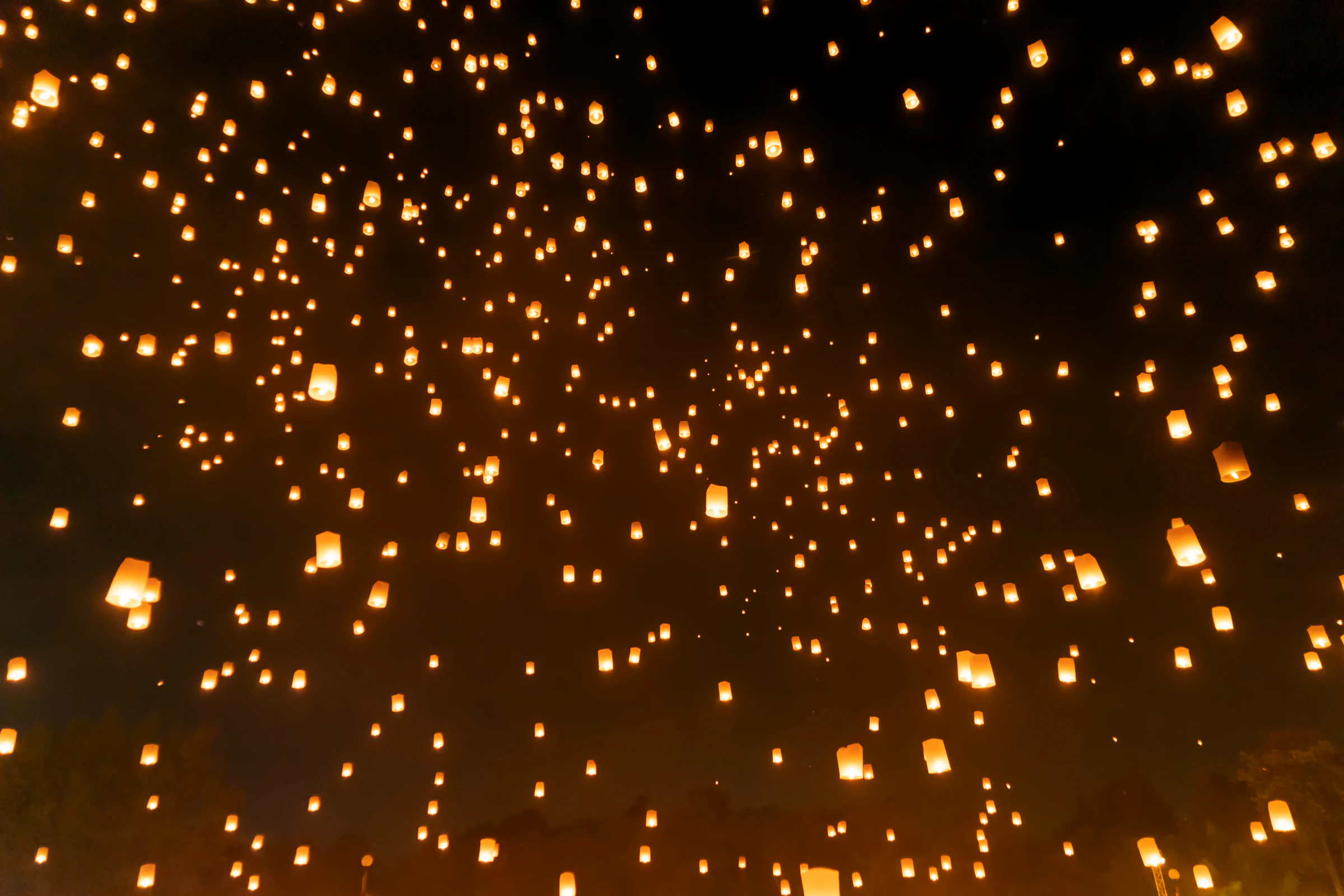 Floating lanterns released into the sky in Chiang Mai during Yi Peng
