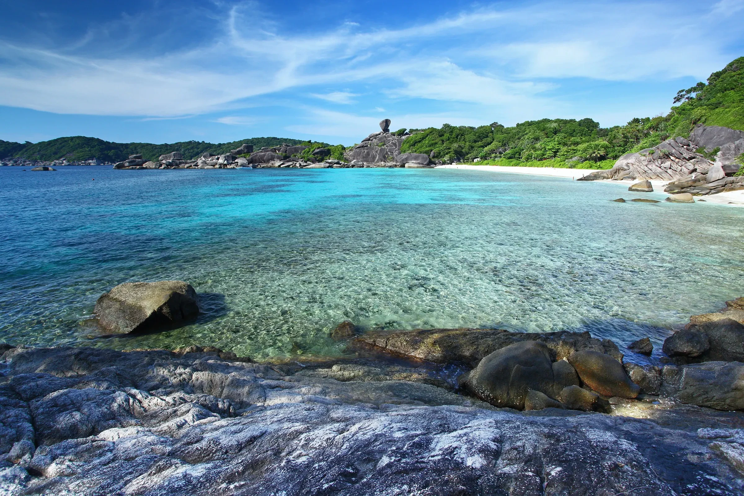 Clear turquoise water and rocks at a beach in Mu Ko Similan National Park