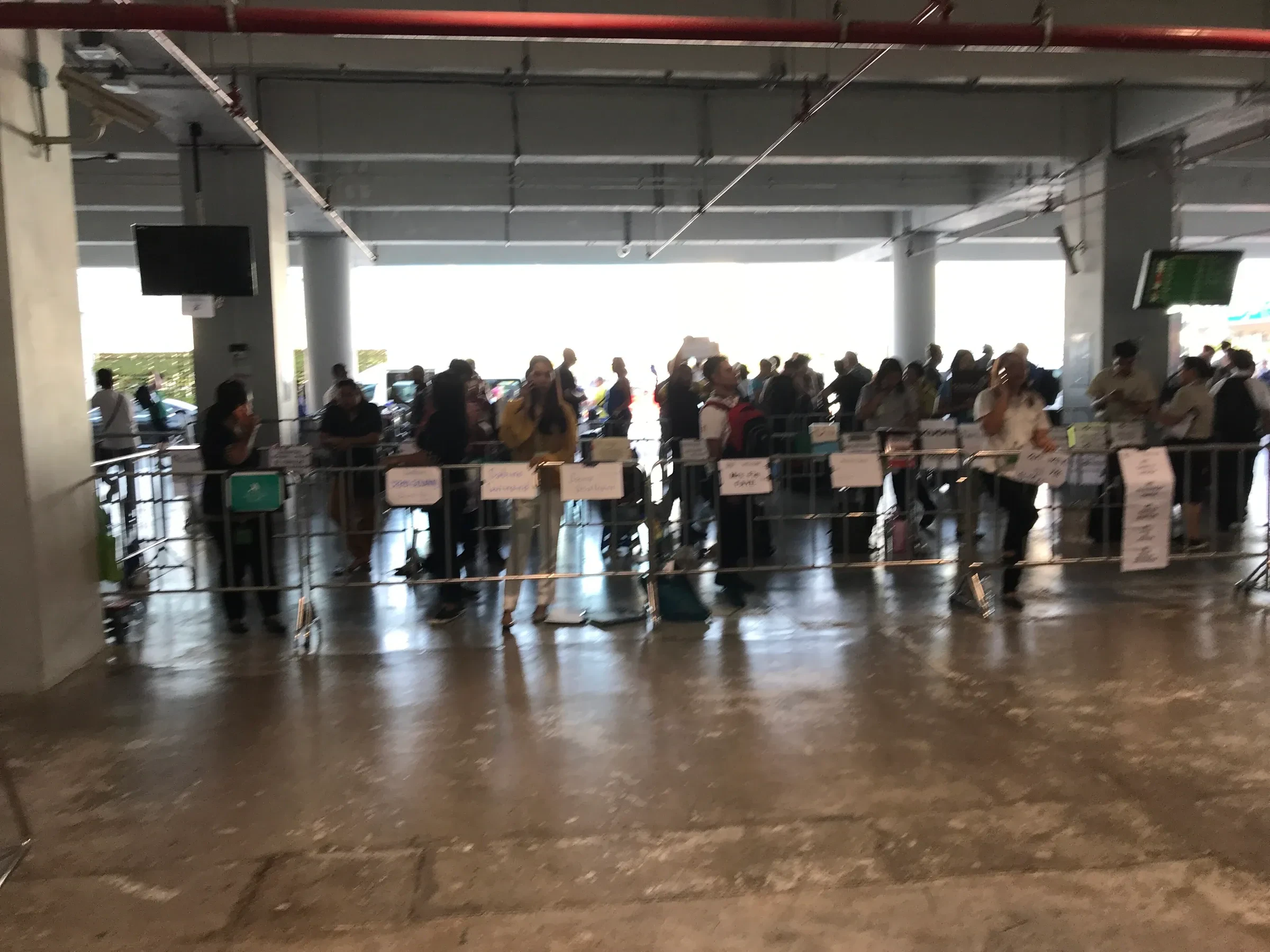 Transport drivers with name signs waiting for arriving passengers at Phuket International Airport