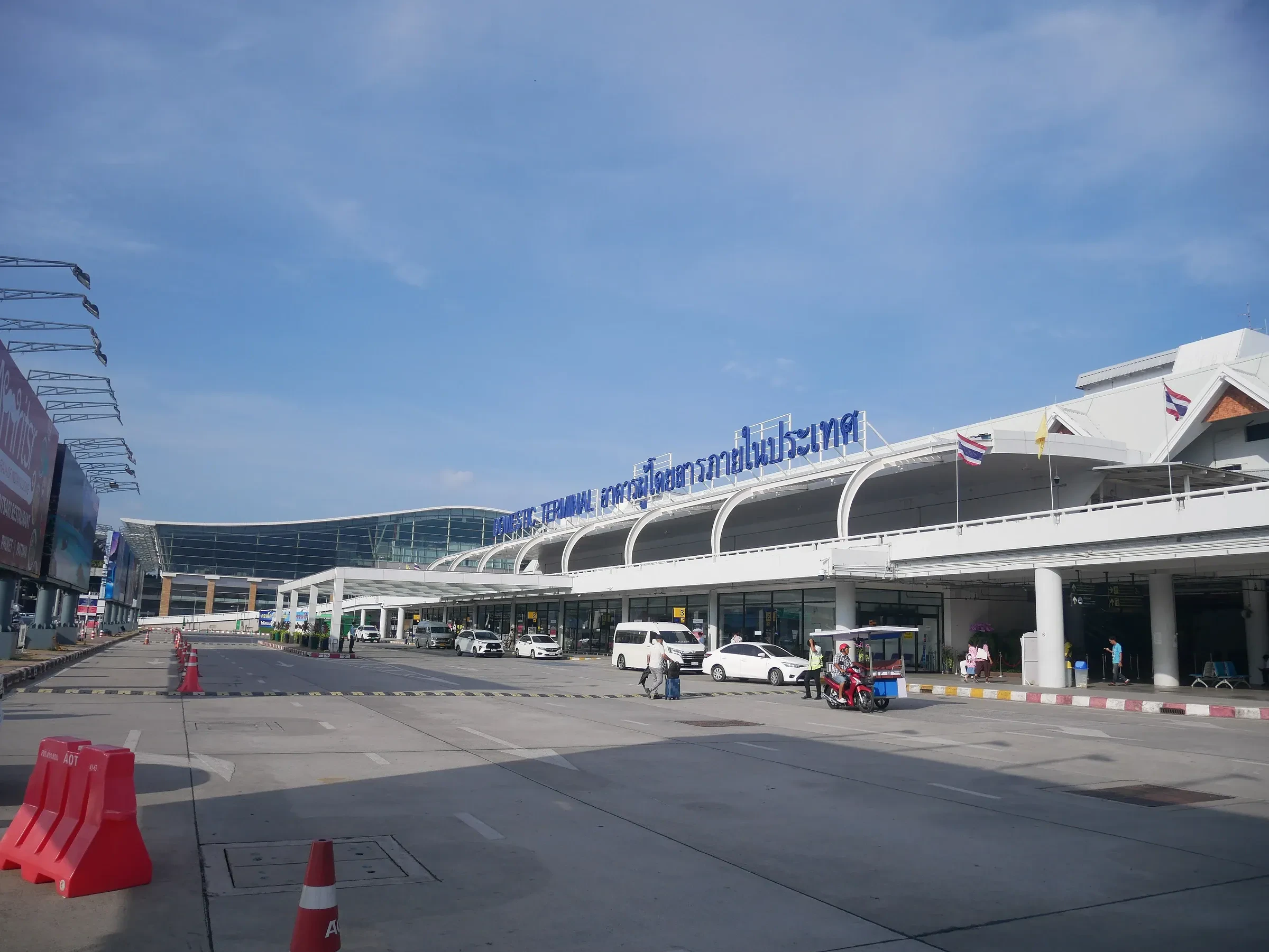 The front of the terminal building at Phuket International Airport under a blue sky