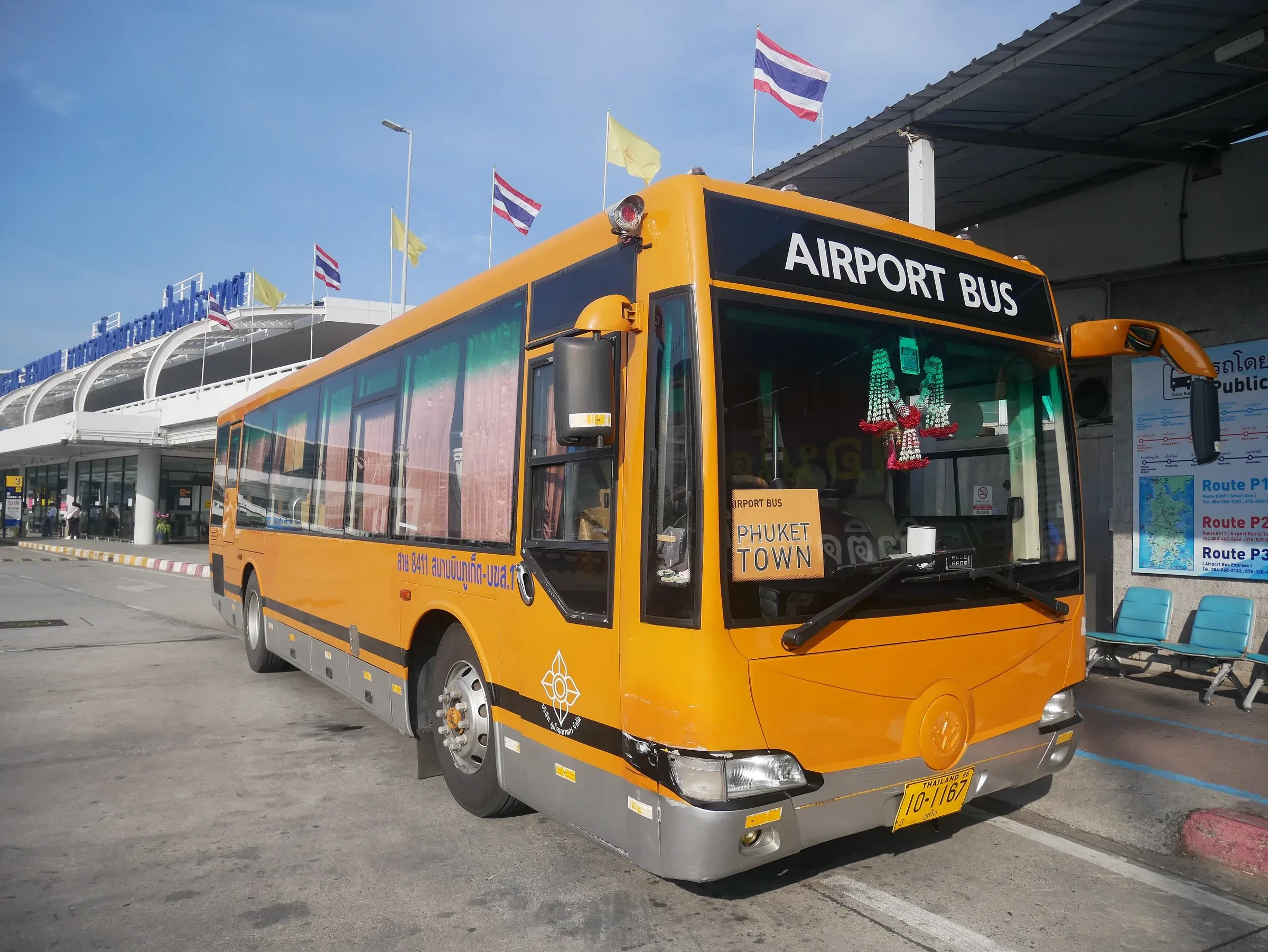 An orange airport bus outside Phuket International Airport