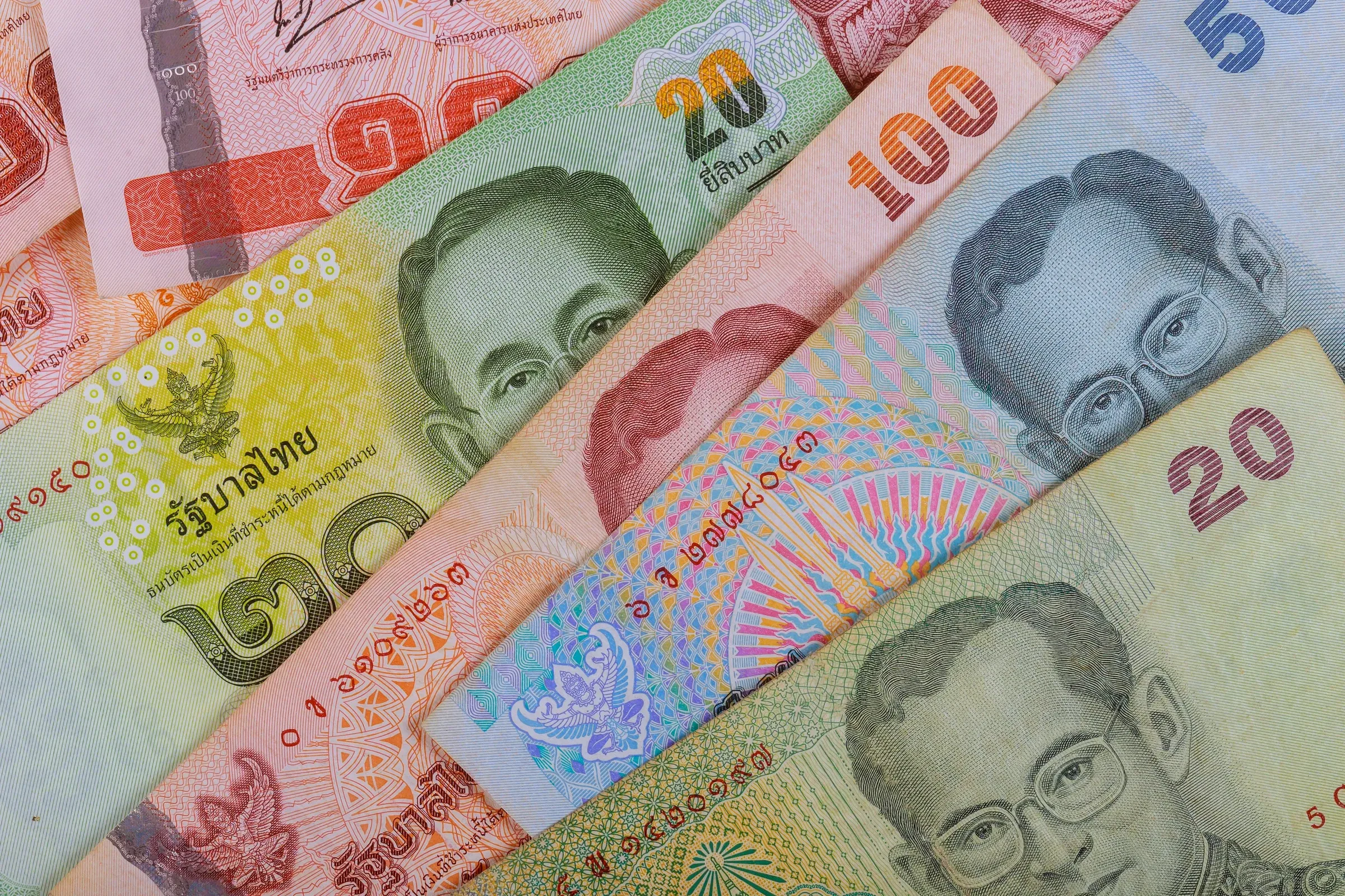 Thai baht banknotes of different values laid out together