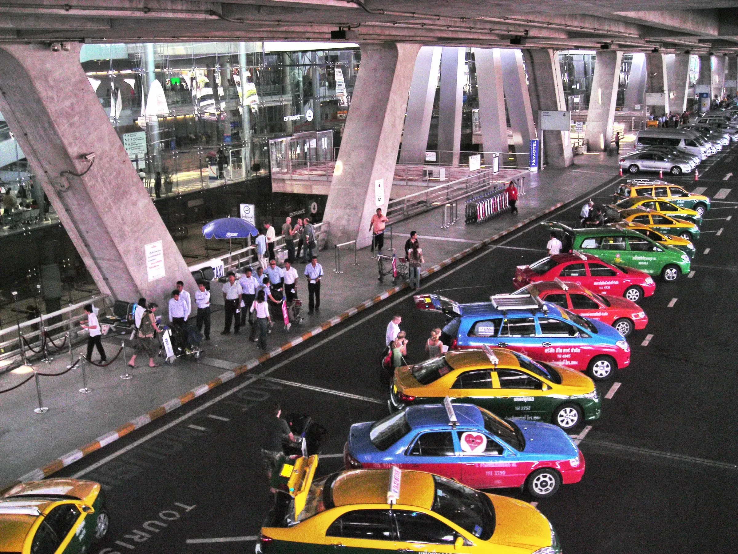 A row of metered taxis waiting at the taxi stand outside Suvarnabhumi Airport