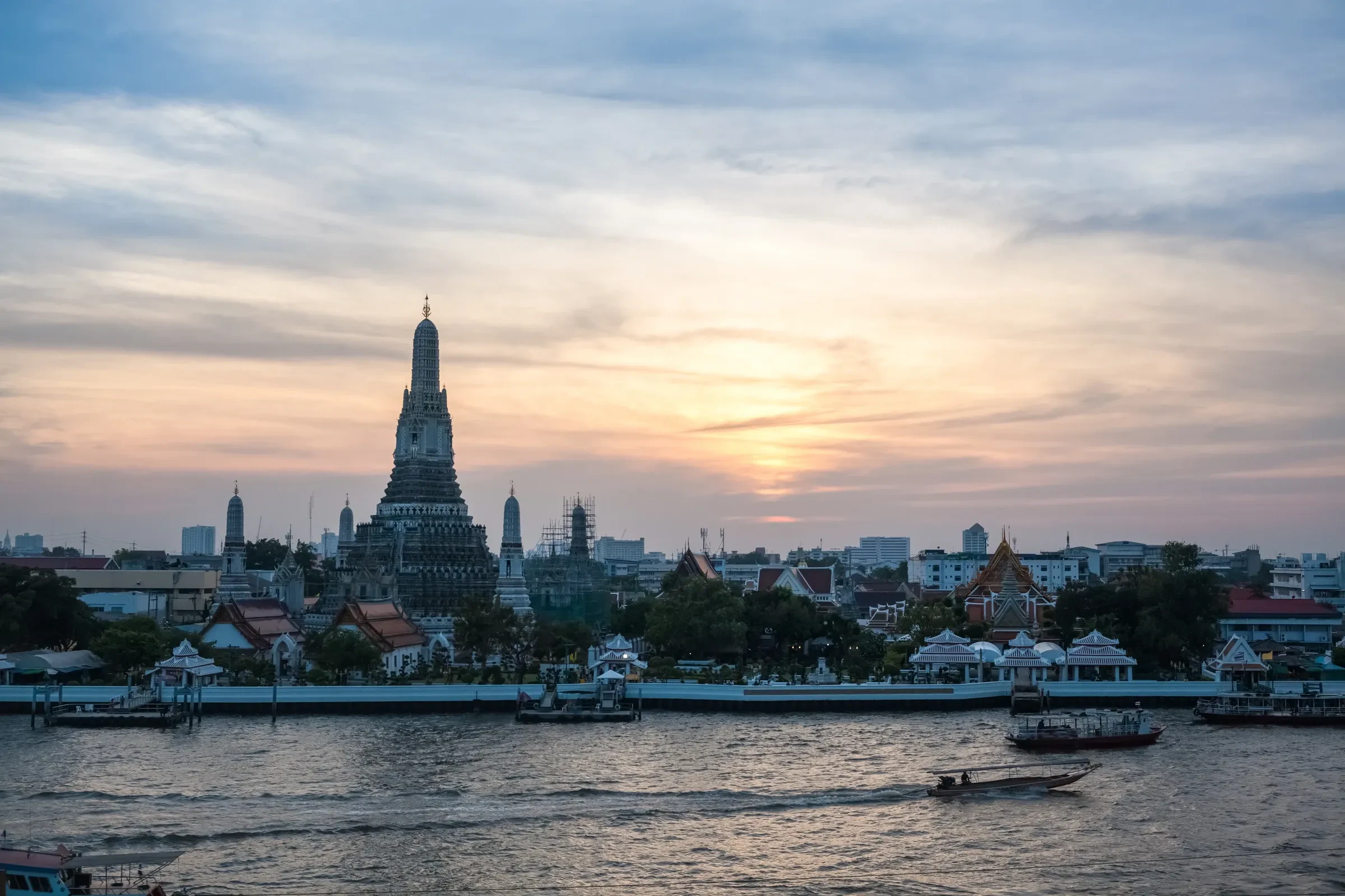 Wat Arun on the Chao Phraya river in Bangkok at sunset