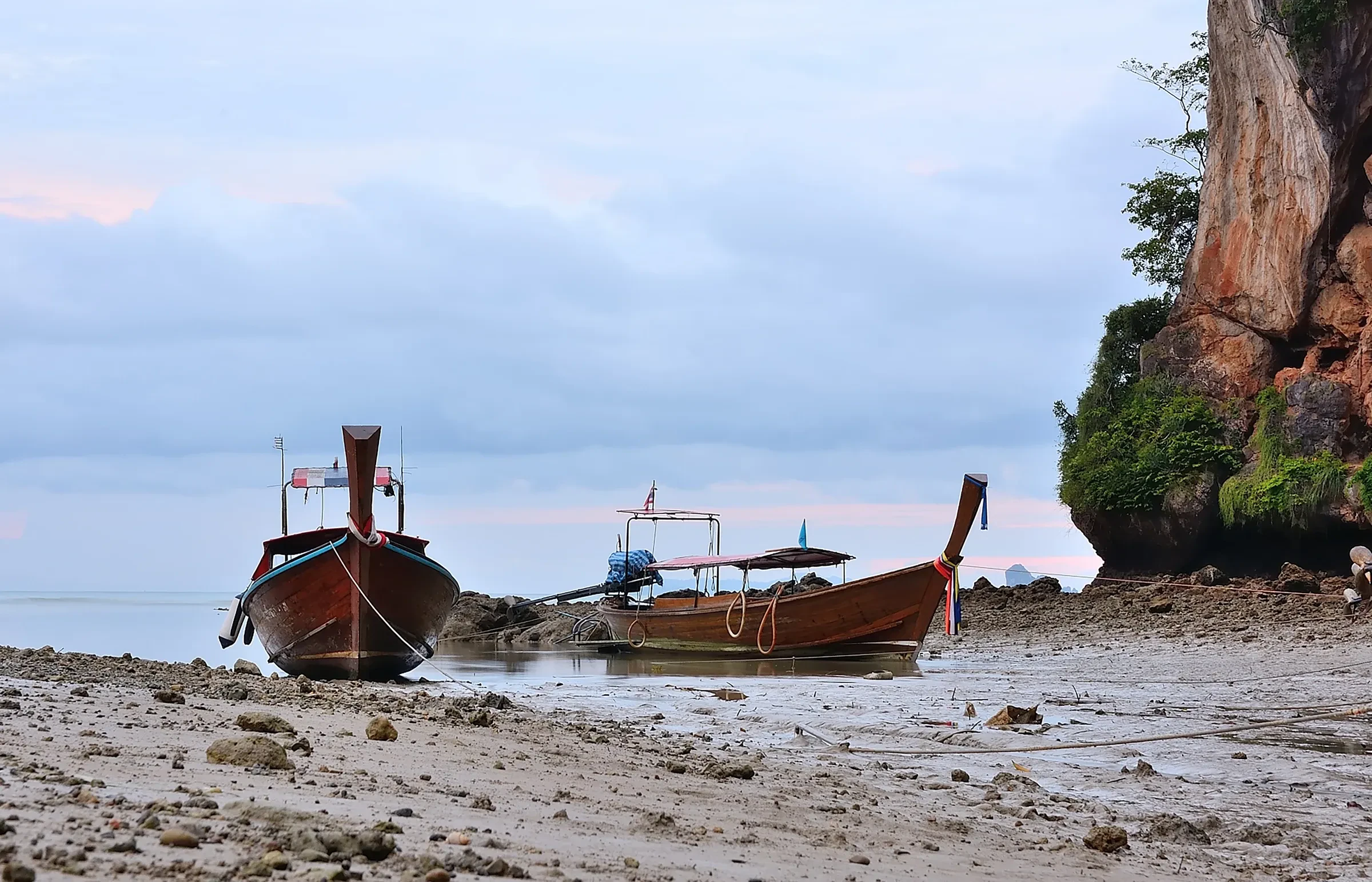 Longtail boats resting on the sand at Railay beach, Krabi