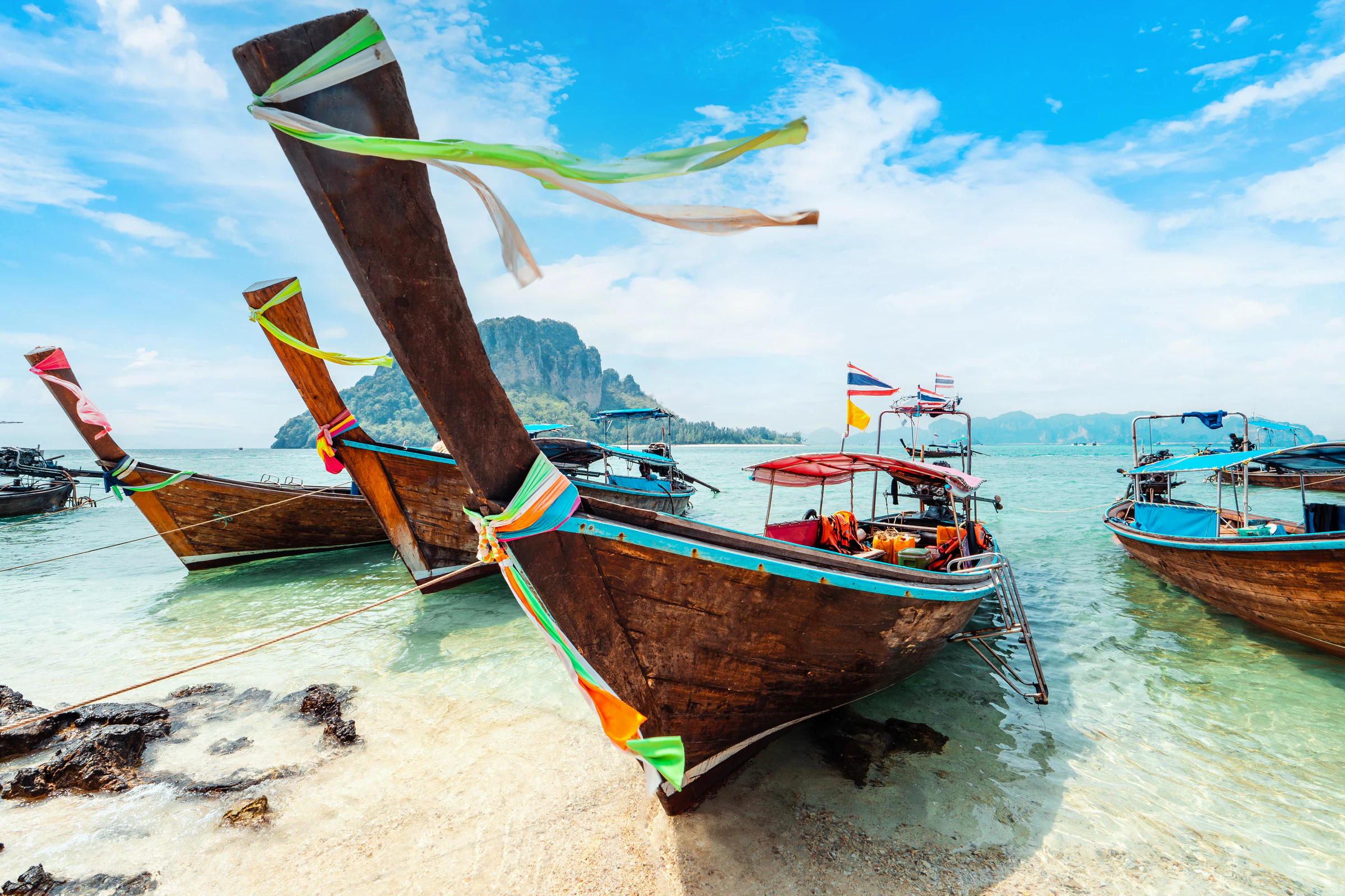 A longtail boat moored off a limestone island on Thailand's Andaman coast