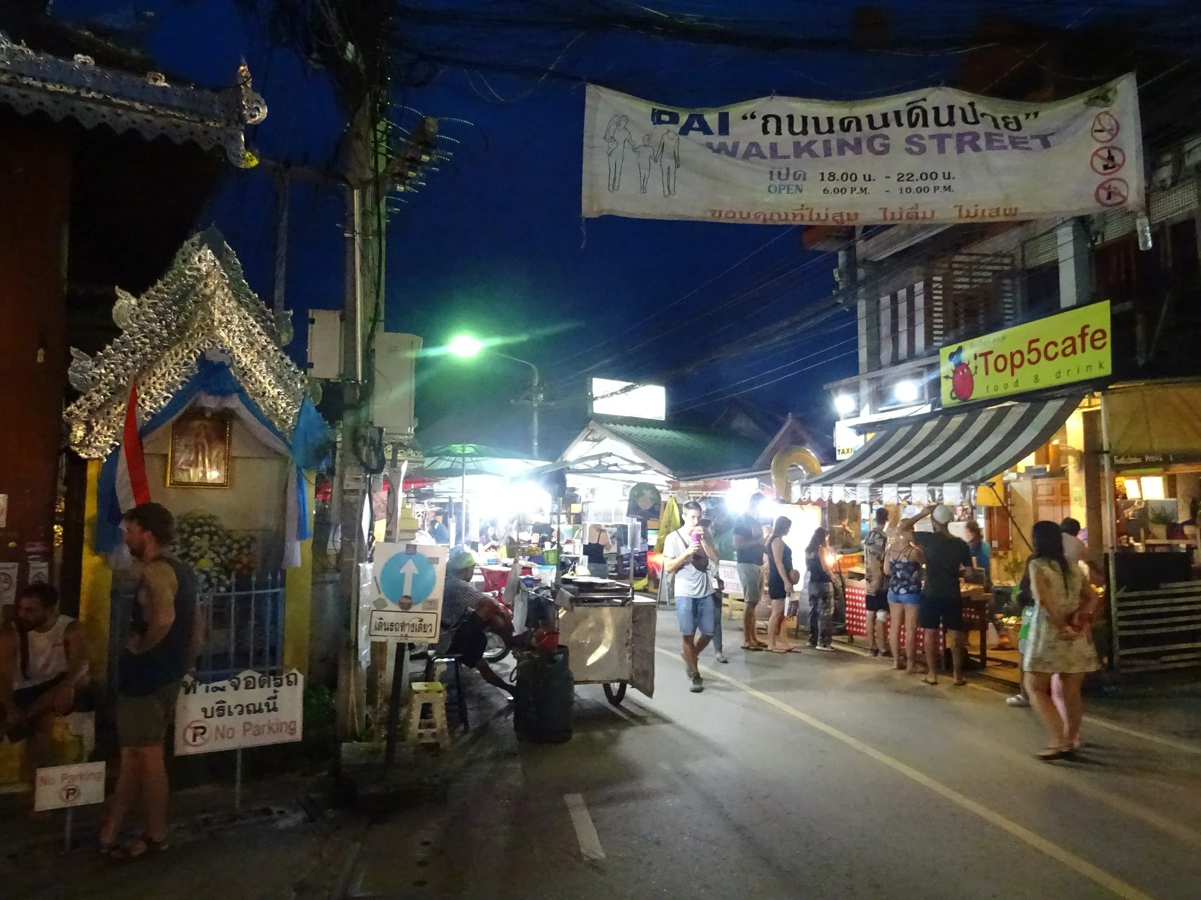 Pai's Walking Street at night, with food stalls and visitors strolling