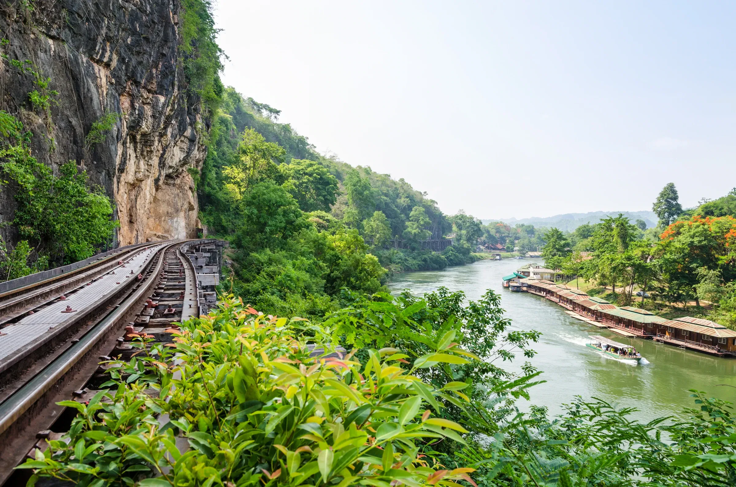 The Death Railway train crossing the wooden Wang Pho viaduct above the river