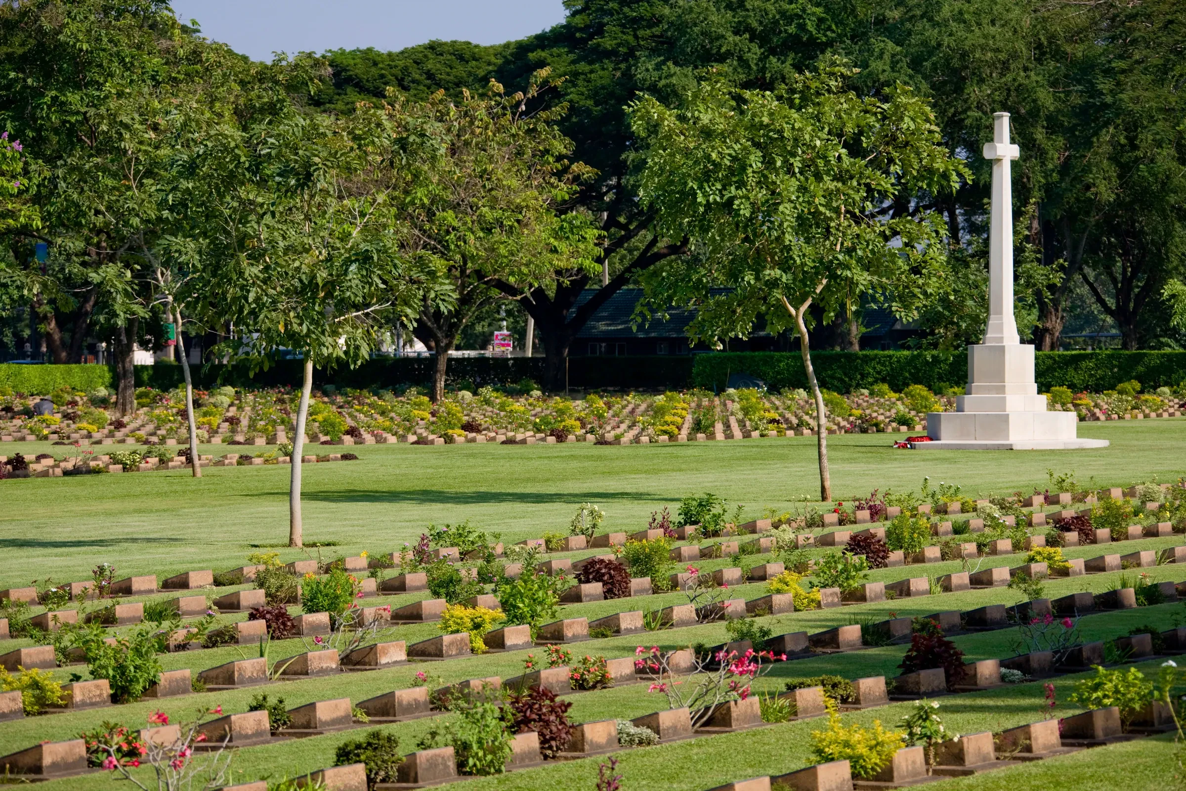 Rows of white headstones at Kanchanaburi War Cemetery