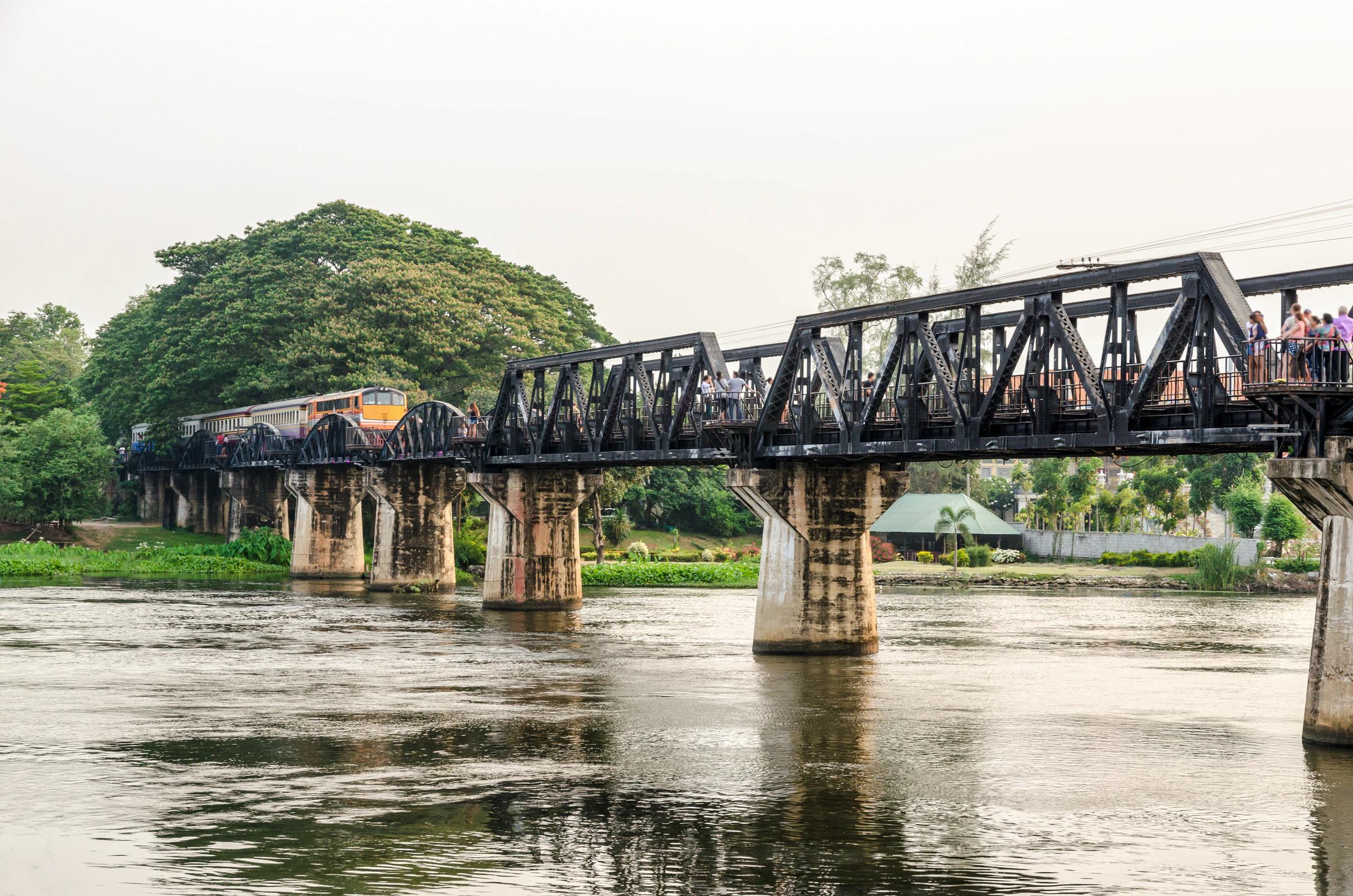 The Bridge on the River Kwai with a train crossing the curved steel spans