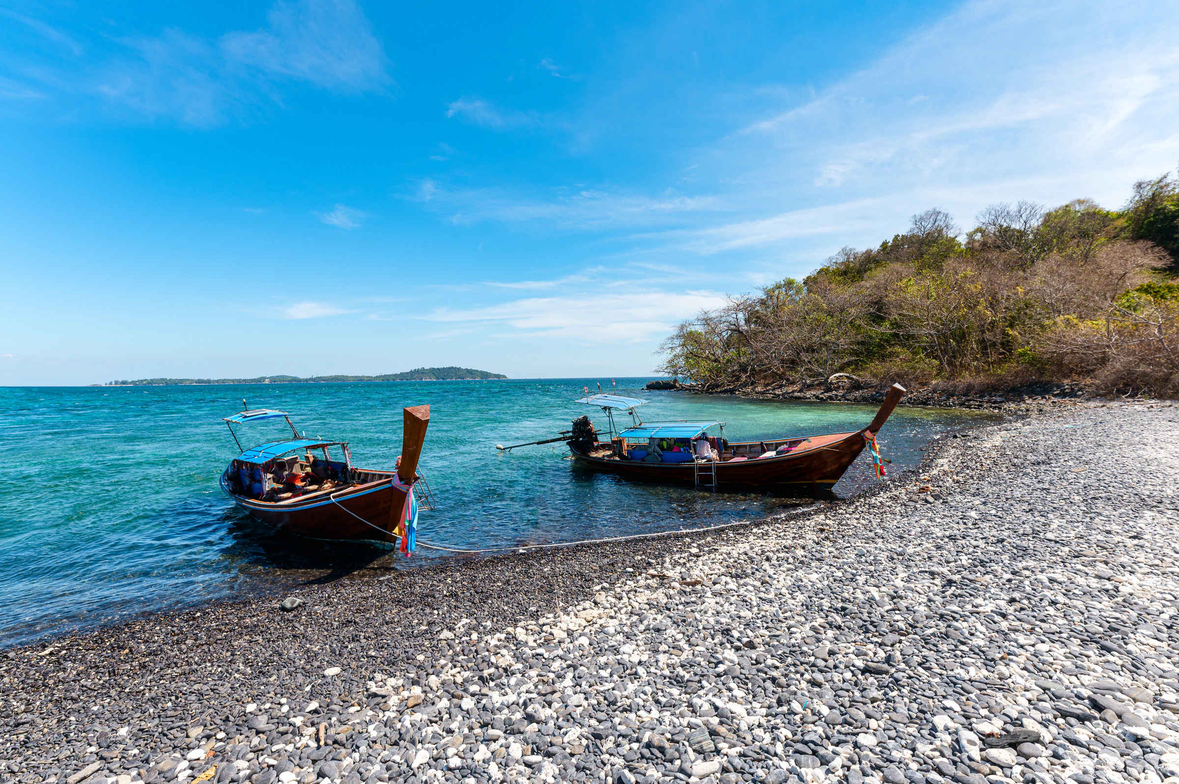 Pattaya Beach on Koh Lipe with longtail boats pulled up on the sand