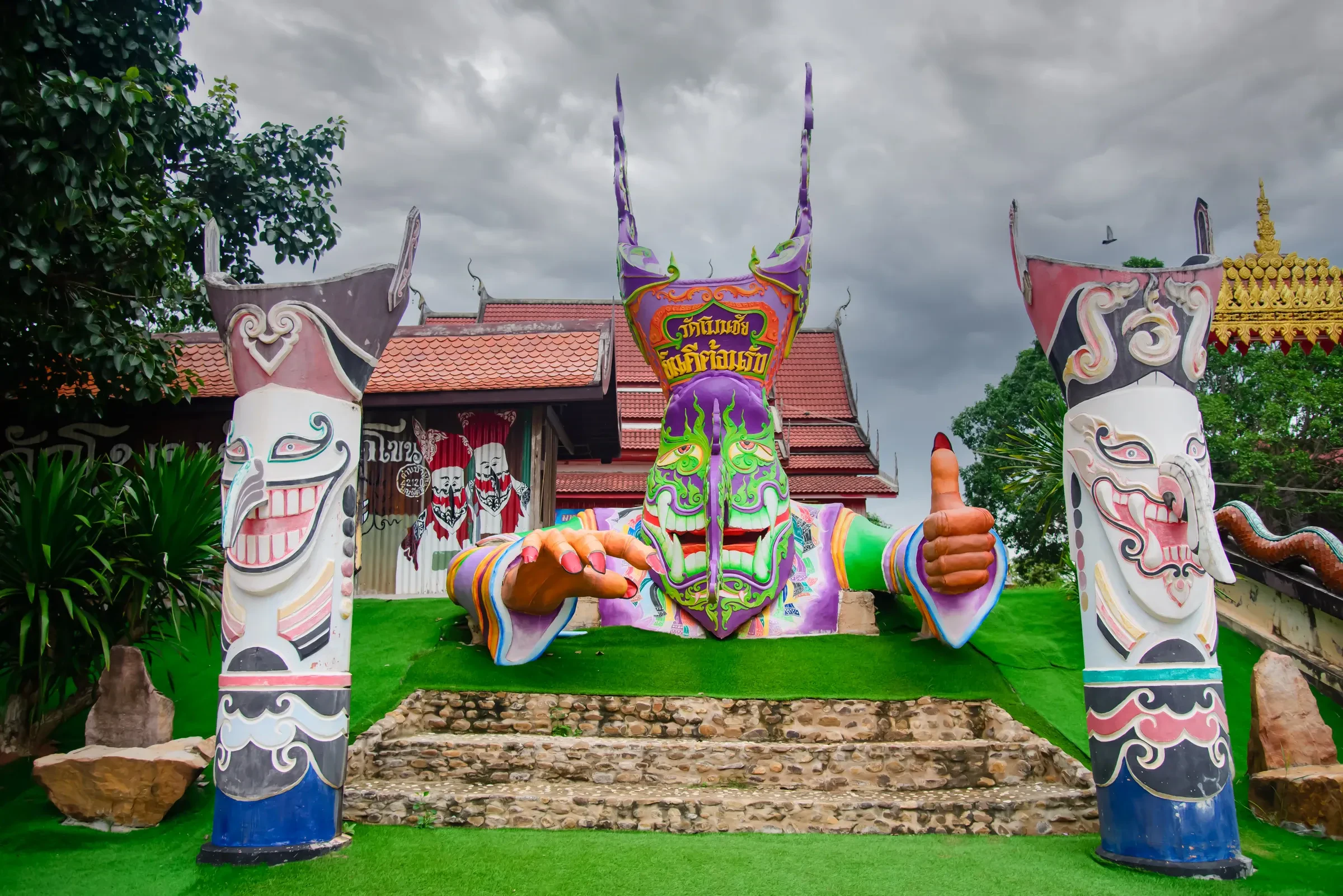 Giant painted Phi Ta Khon figures in front of Wat Phon Chai in Dan Sai