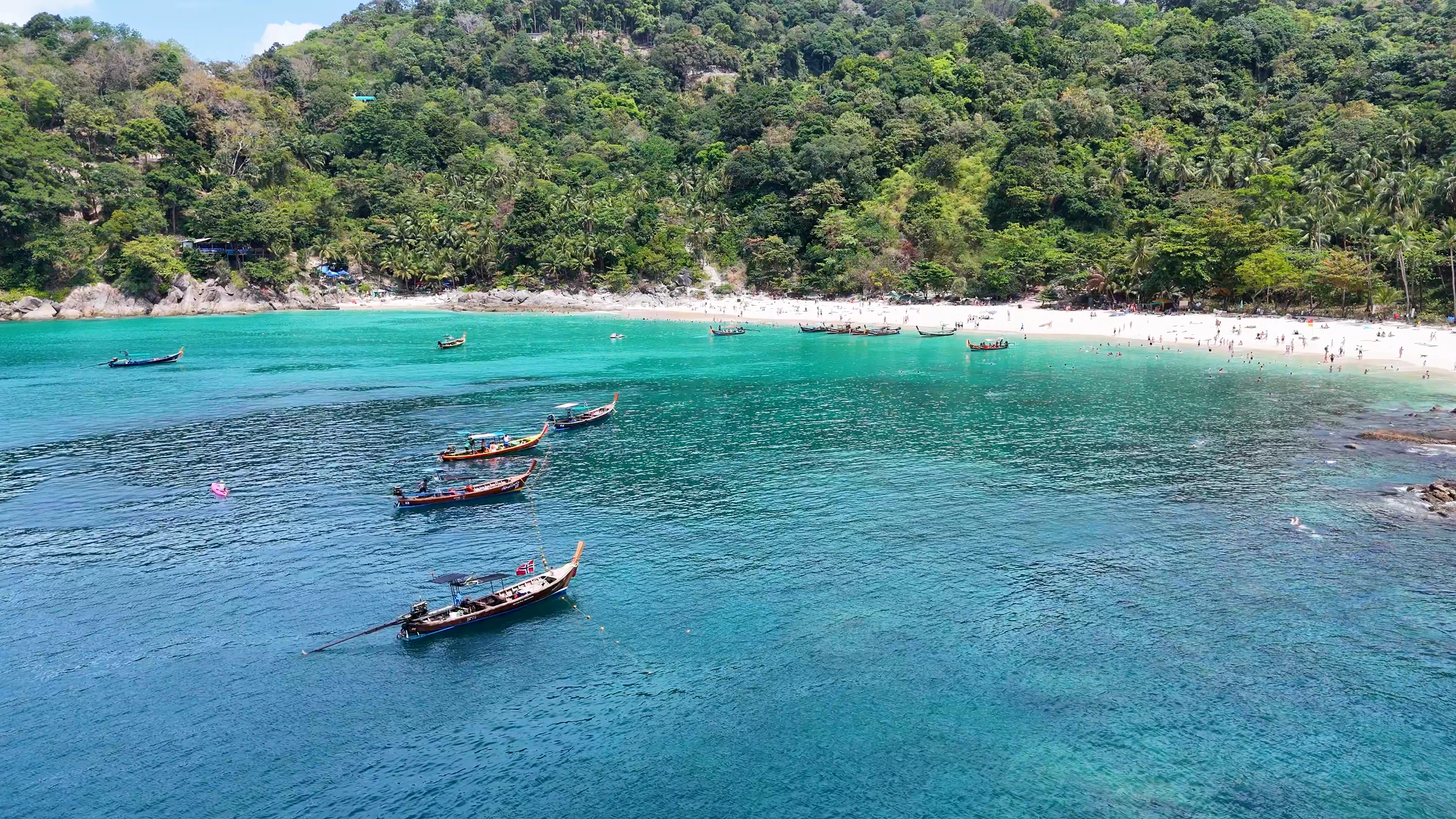 Longtail boats in a turquoise bay off Phuket, Thailand