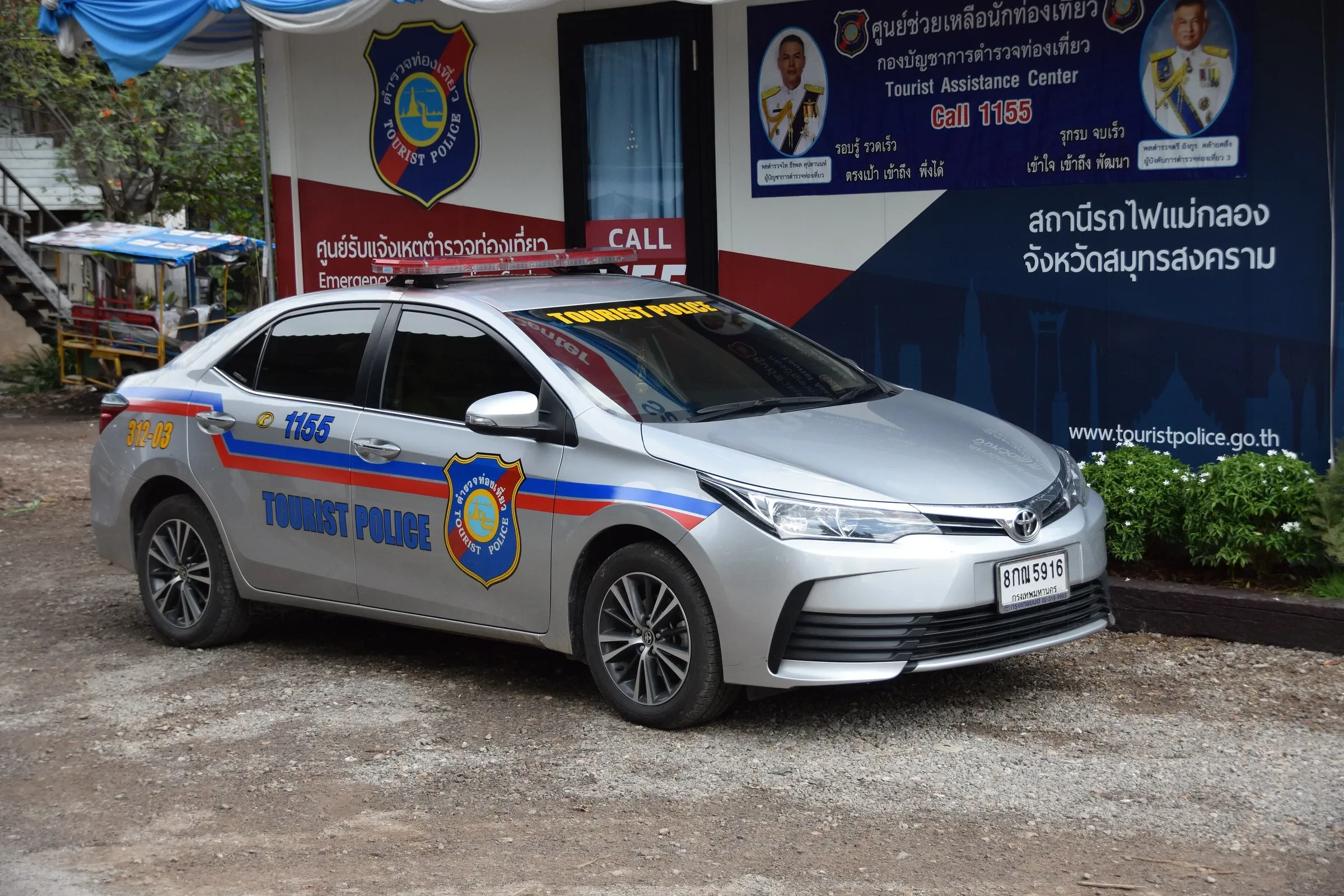A Tourist Police car parked outside a Tourist Assistance Center in Thailand