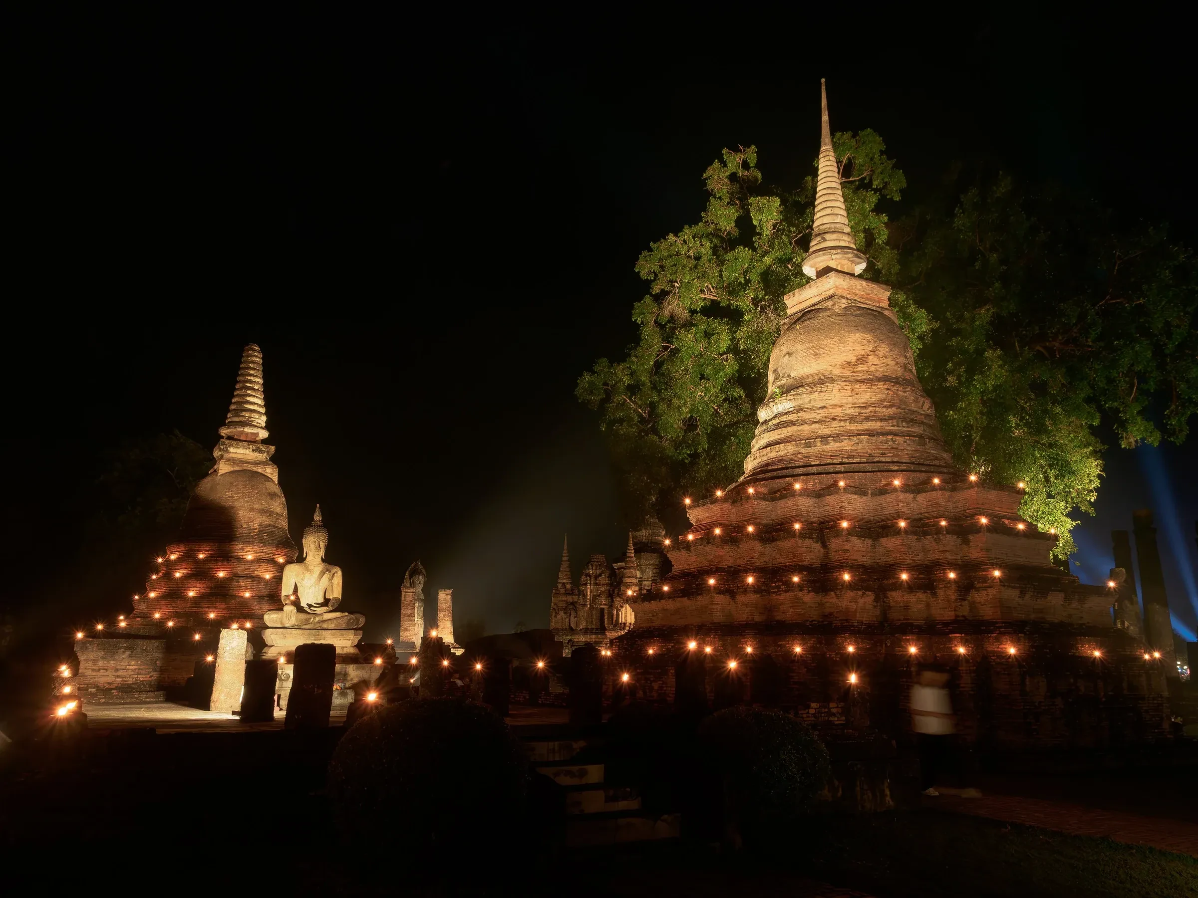 Candlelit chedis at Sukhothai Historical Park during the Loy Krathong festival