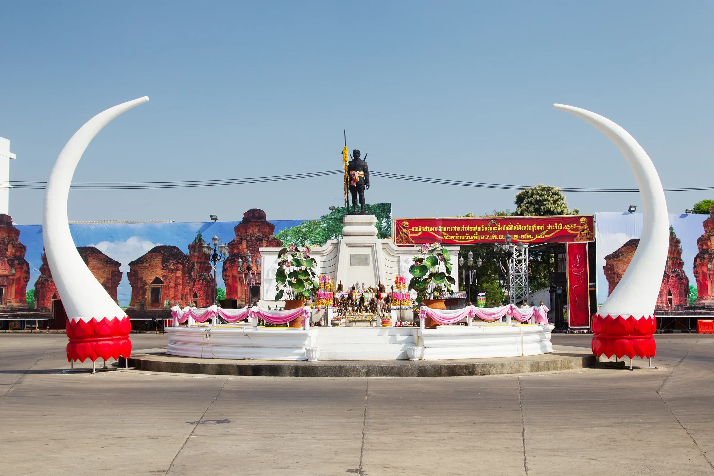 The monument to Phaya Surin Phakdi Si Narong Changwang between two giant white tusk sculptures in Surin city