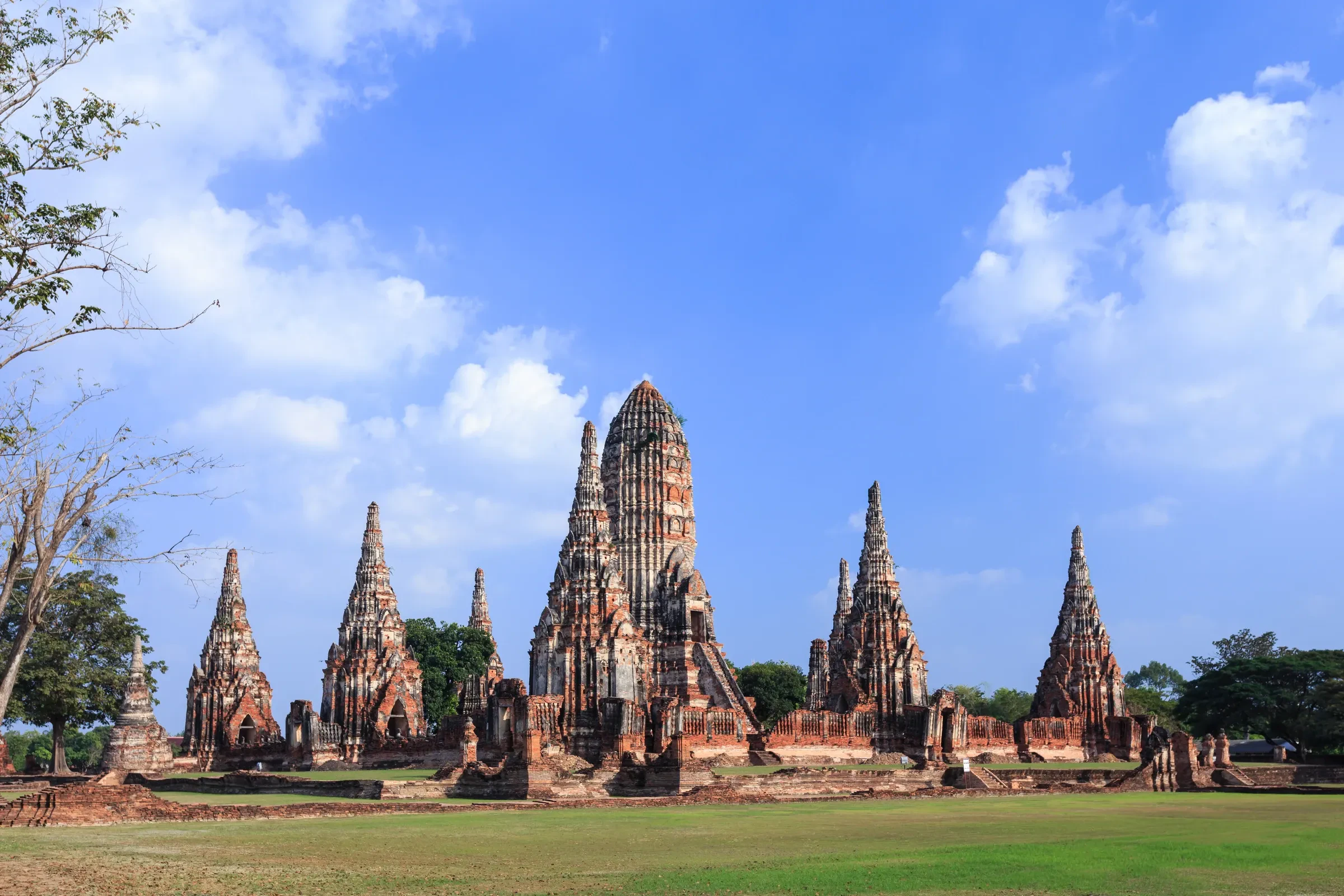 Brick prangs of Wat Chaiwatthanaram in Ayutthaya Historical Park under a blue sky