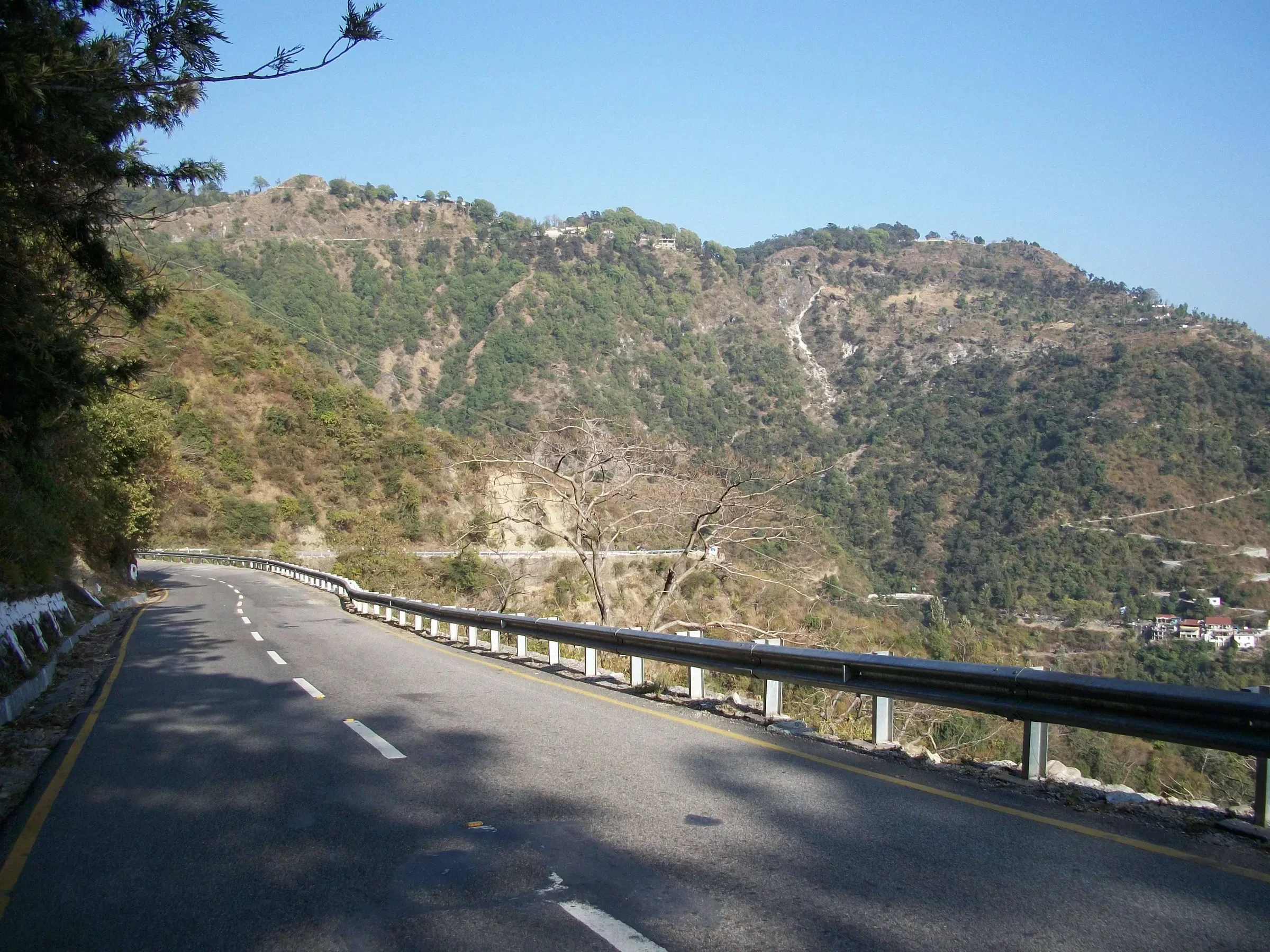 A hill road curving along the slopes between Dehradun and Mussoorie