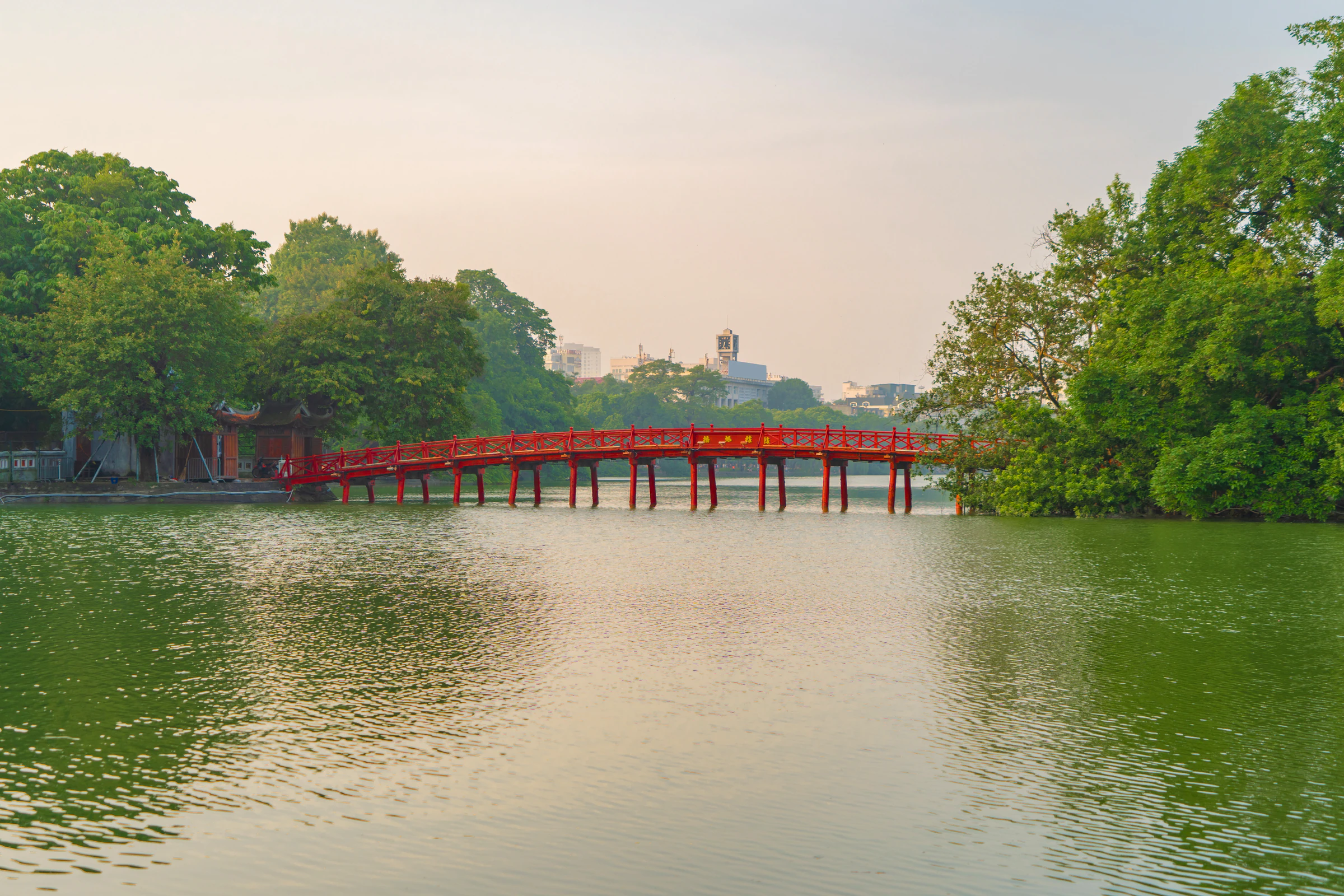 A red footbridge over Hoan Kiem Lake in central Hanoi