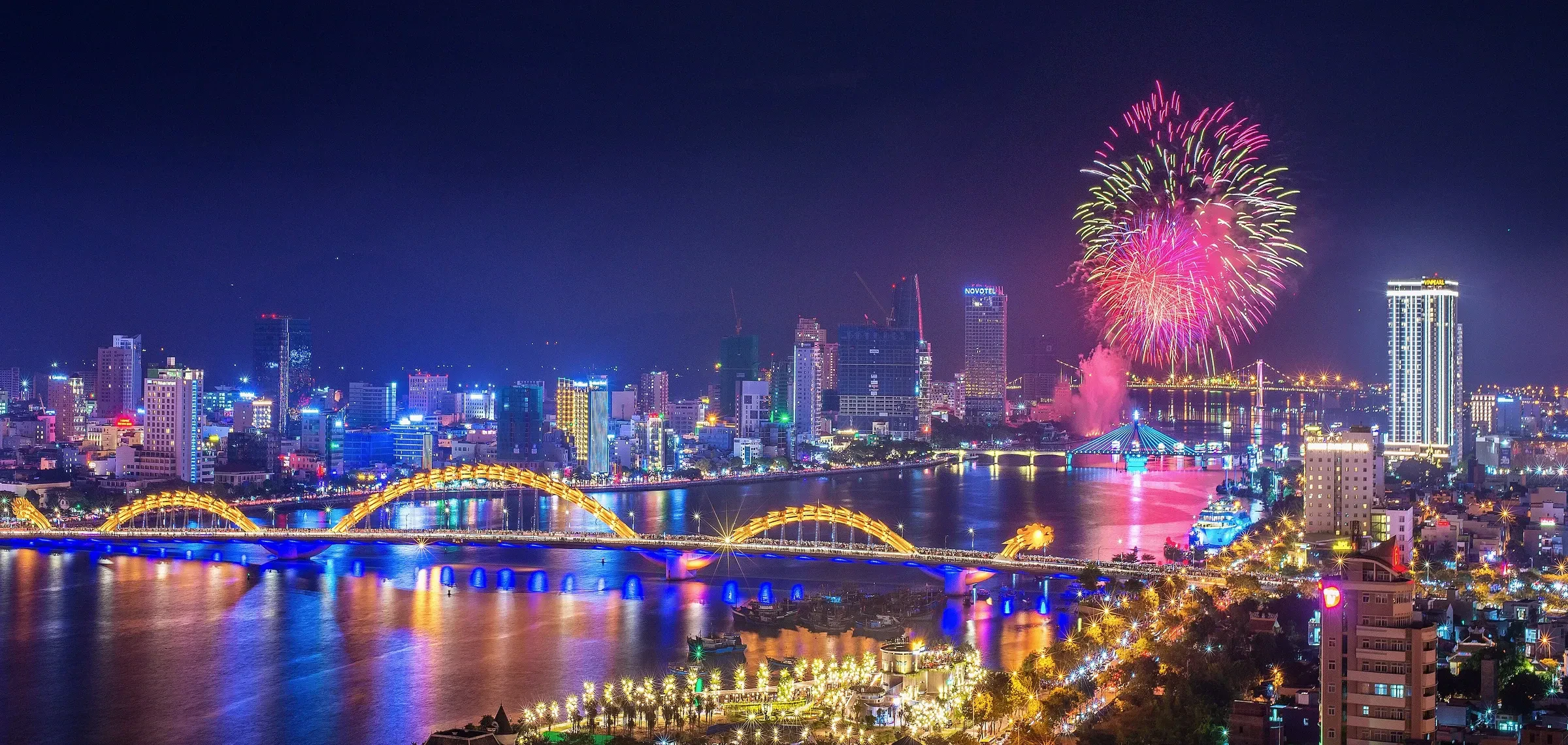 Fireworks over the Han River in Da Nang with the Dragon Bridge and city skyline lit up at night