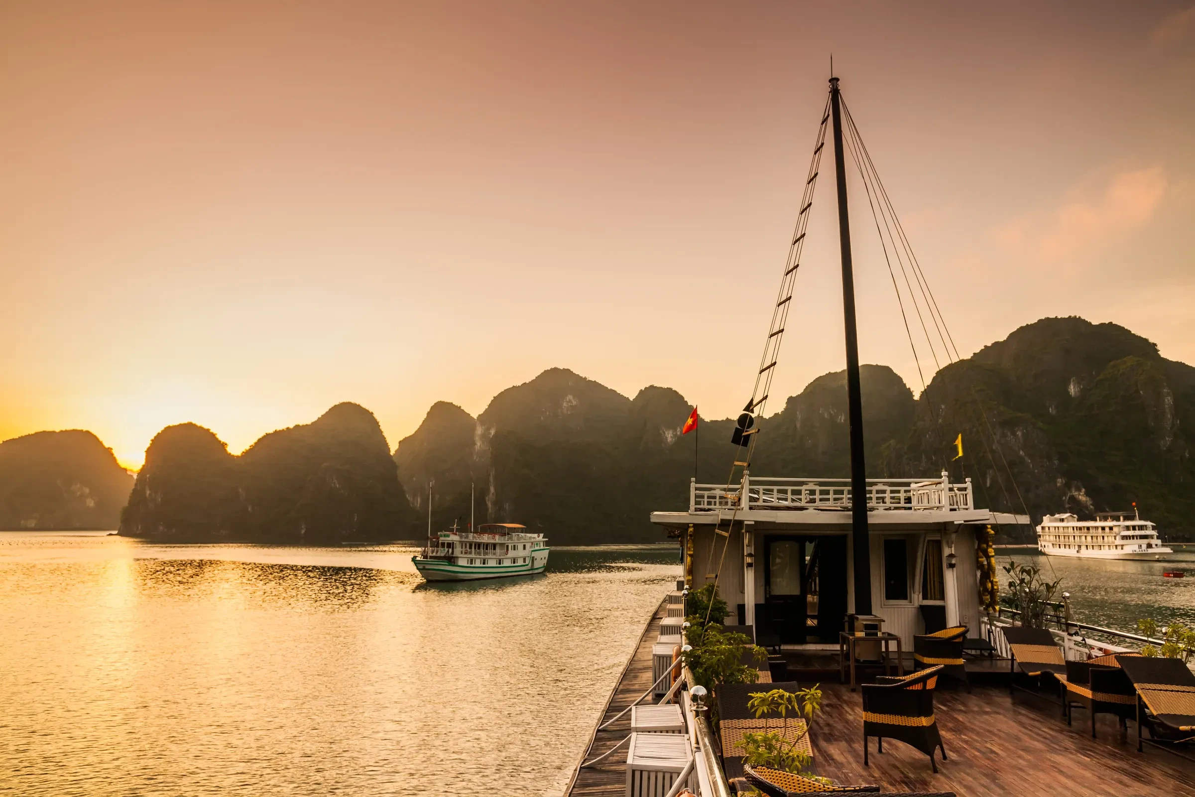 Sunset over the limestone islands from the deck of a cruise boat in Ha Long Bay