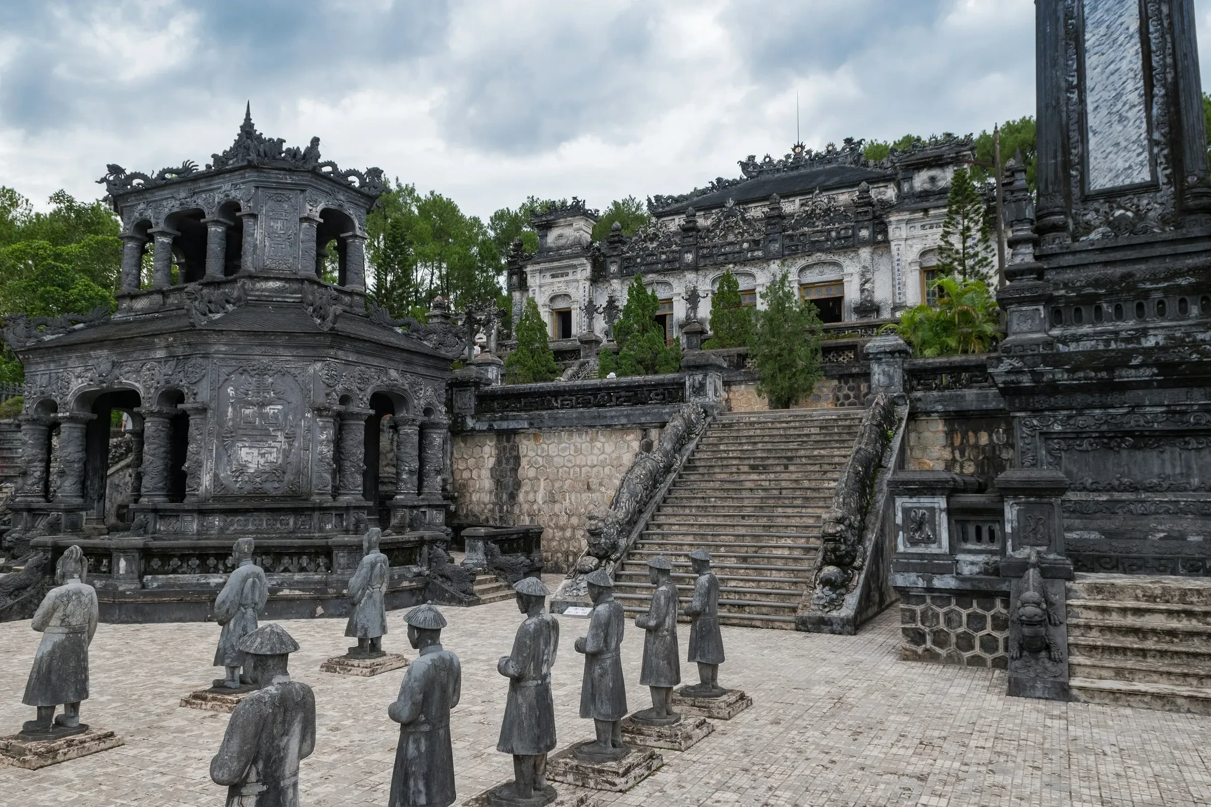 Stone mandarin statues and pavilions in the courtyard of Khai Dinh's tomb near Hue
