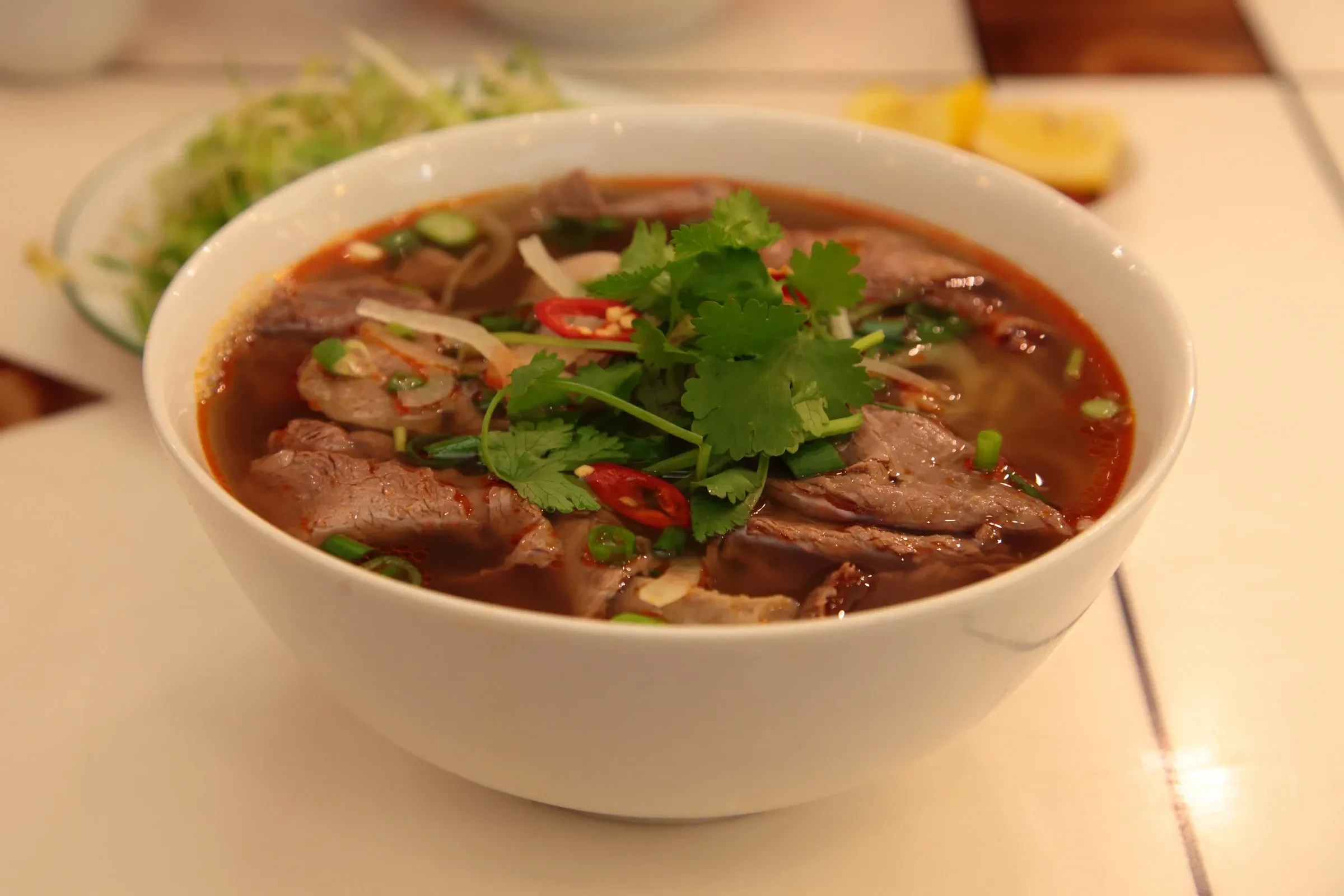 A bowl of bun bo Hue, the city's spicy lemongrass beef noodle soup