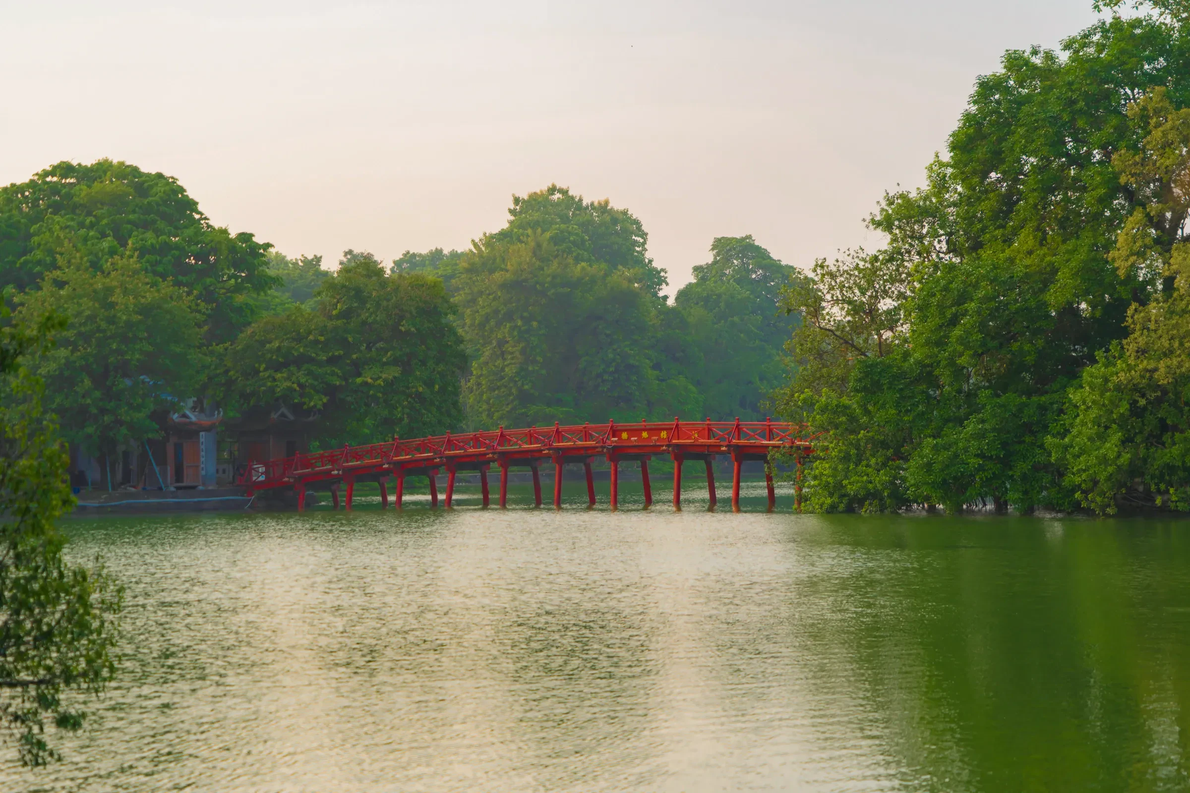 The red Huc Bridge across Hoan Kiem Lake in Hanoi