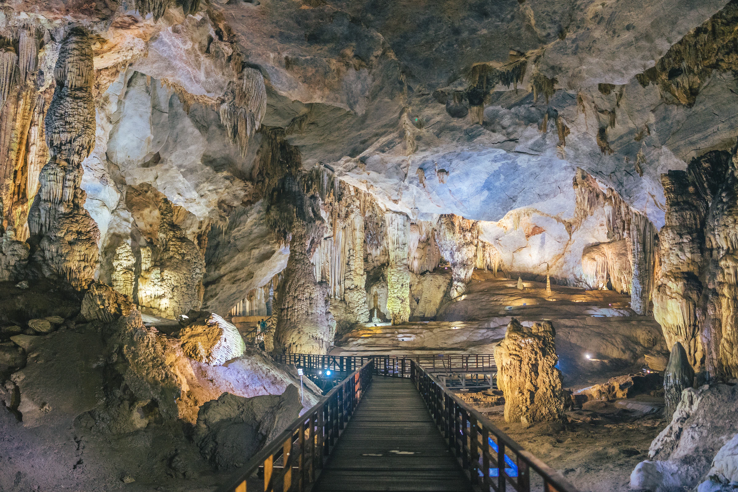 A wooden boardwalk running through the huge stalactite-filled chambers of Paradise Cave in Phong Nha