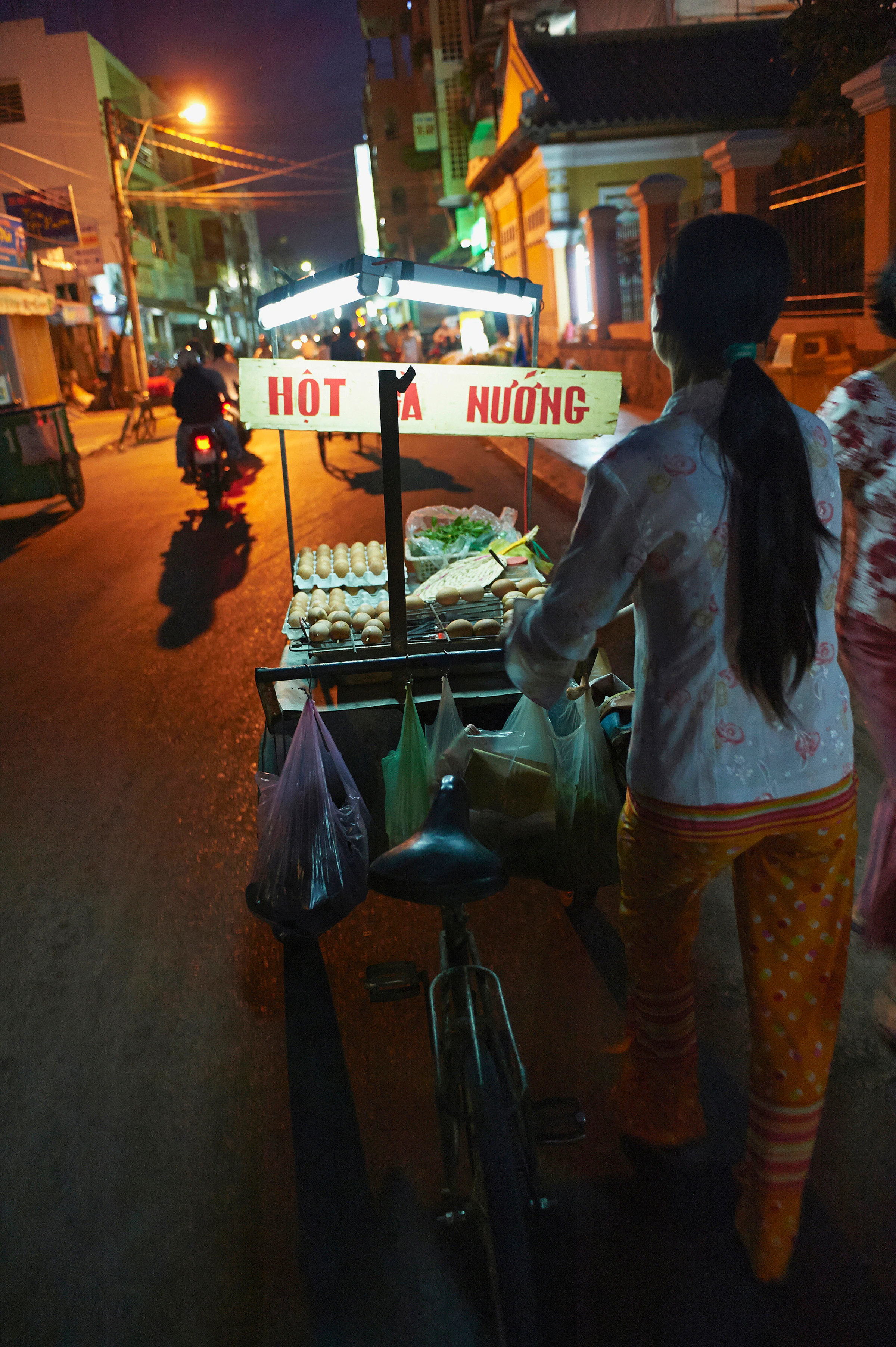 A street vendor with a cycle cart at night in Can Tho