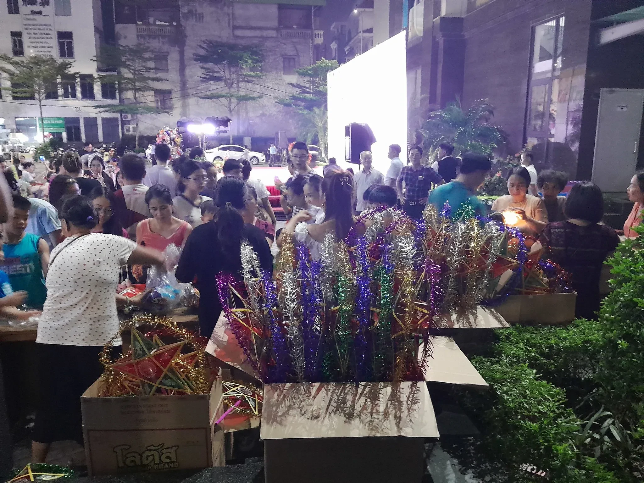 Crowds browsing lantern stalls at a Mid-Autumn night event in a Hanoi neighbourhood, 2025