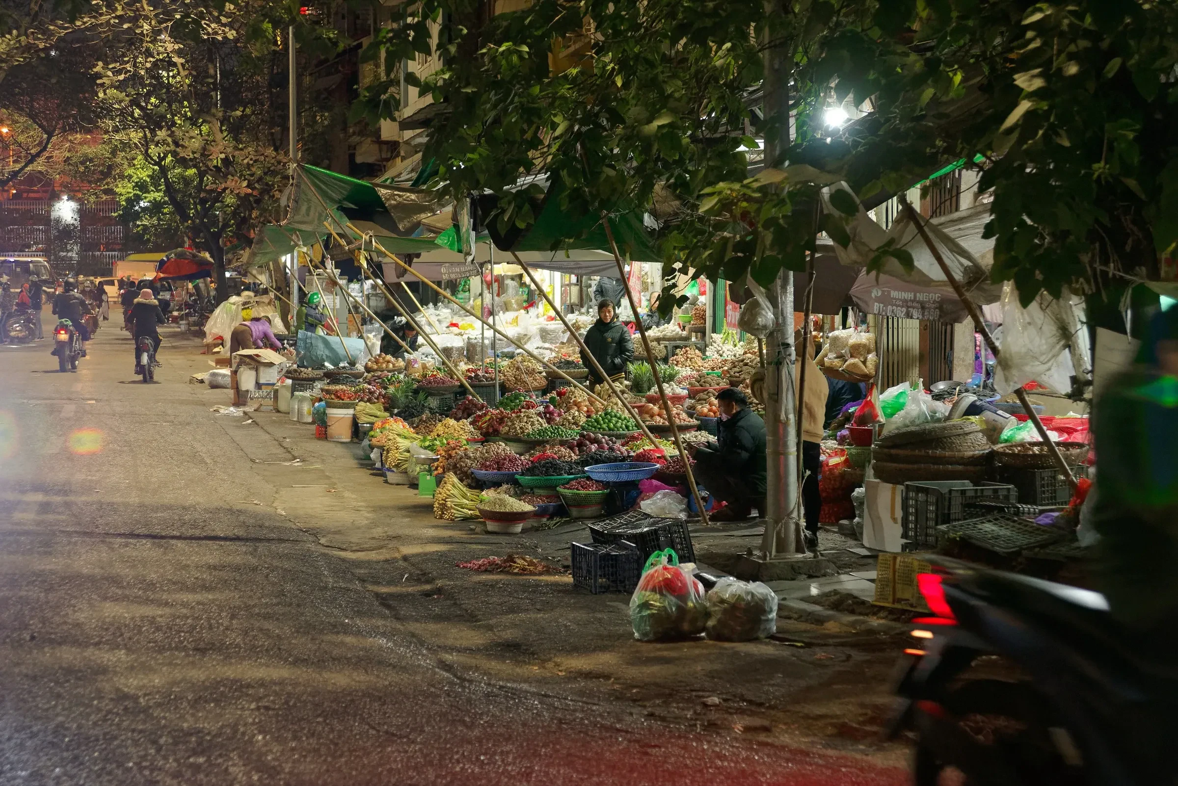 A night market with produce stalls along a street in Hanoi's Old Quarter