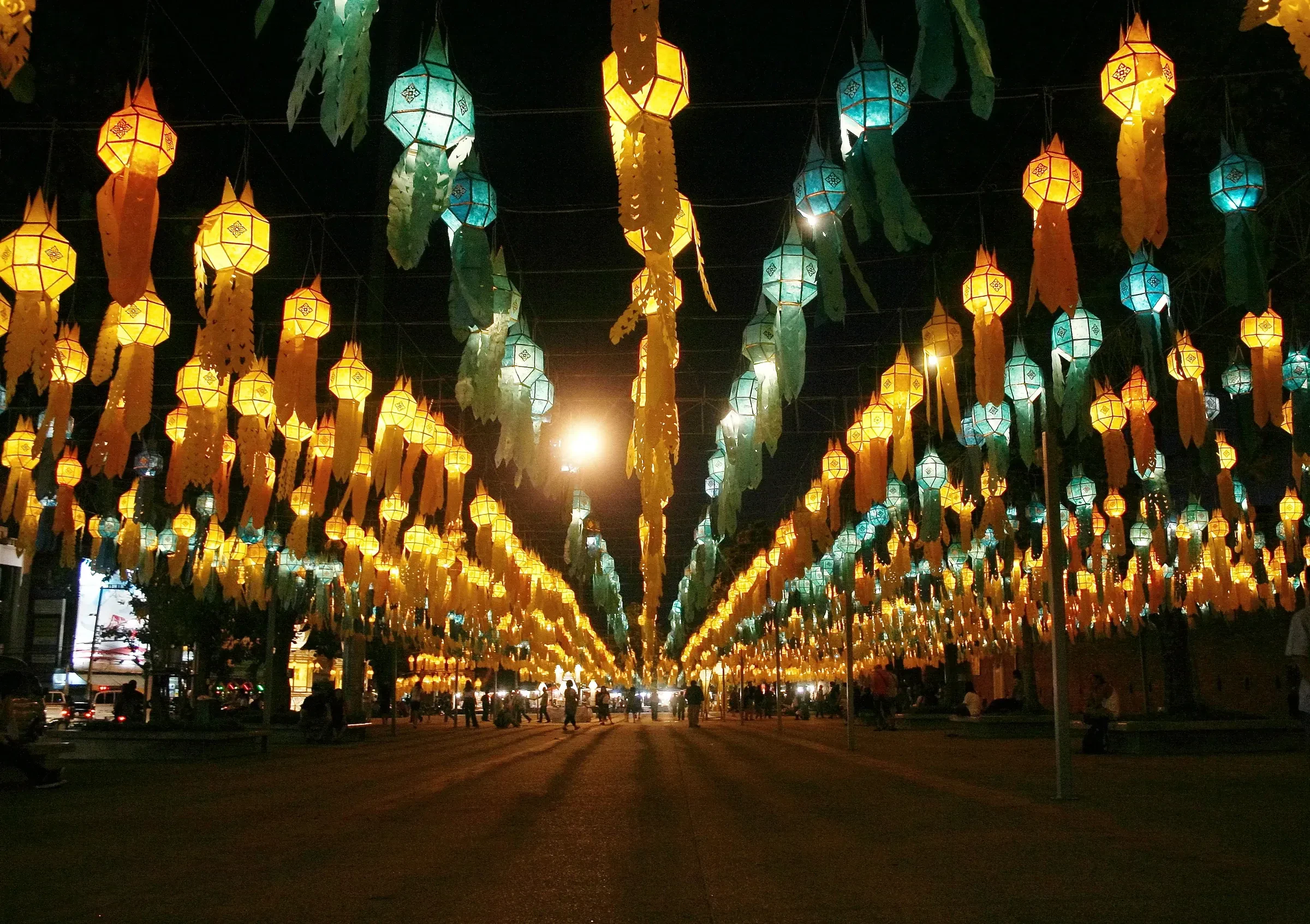 Rows of colourful hanging lanterns lit above a street at Tha Phae Gate in Chiang Mai