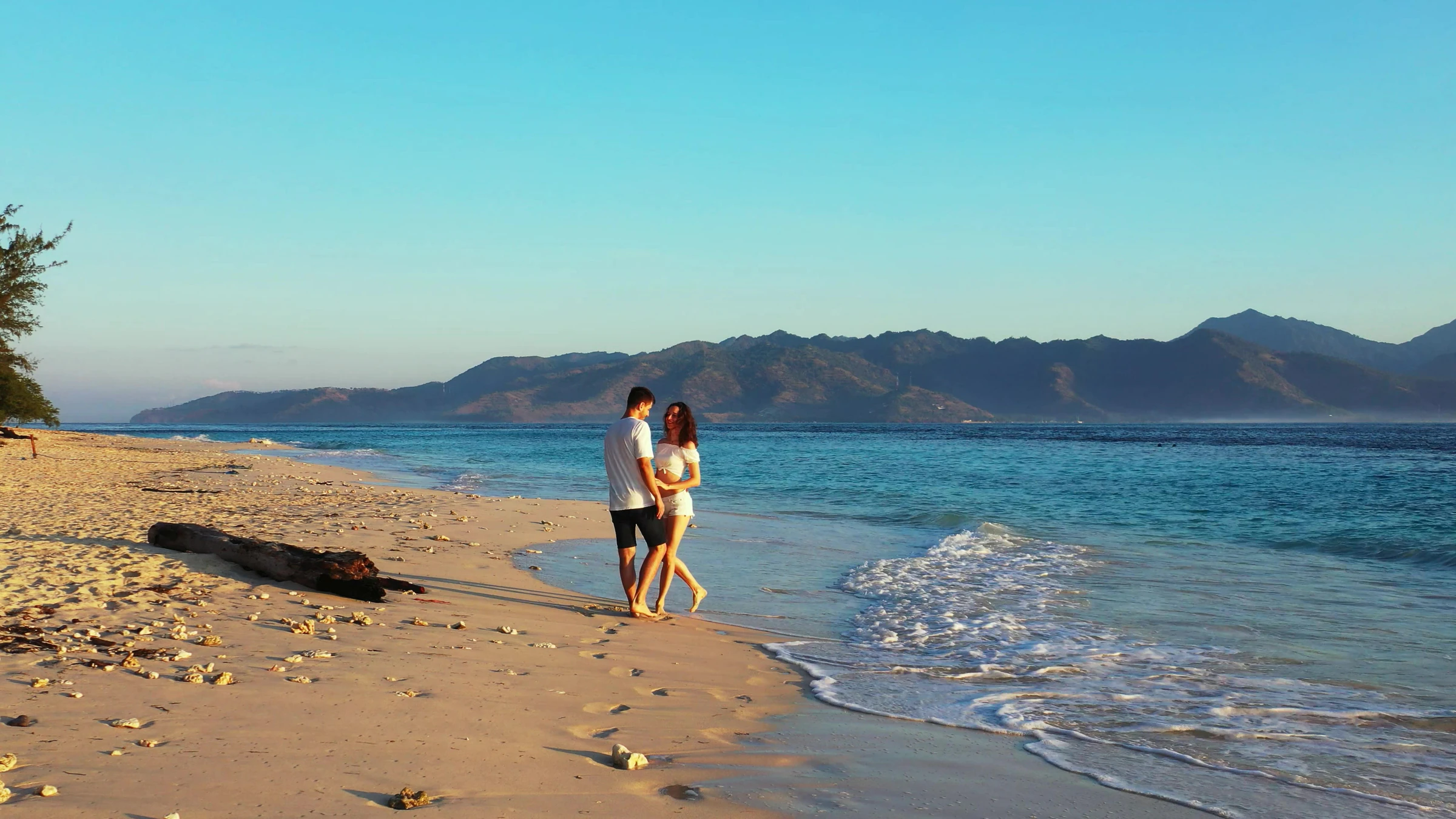 A couple walking along the beach at Gili Meno, Indonesia