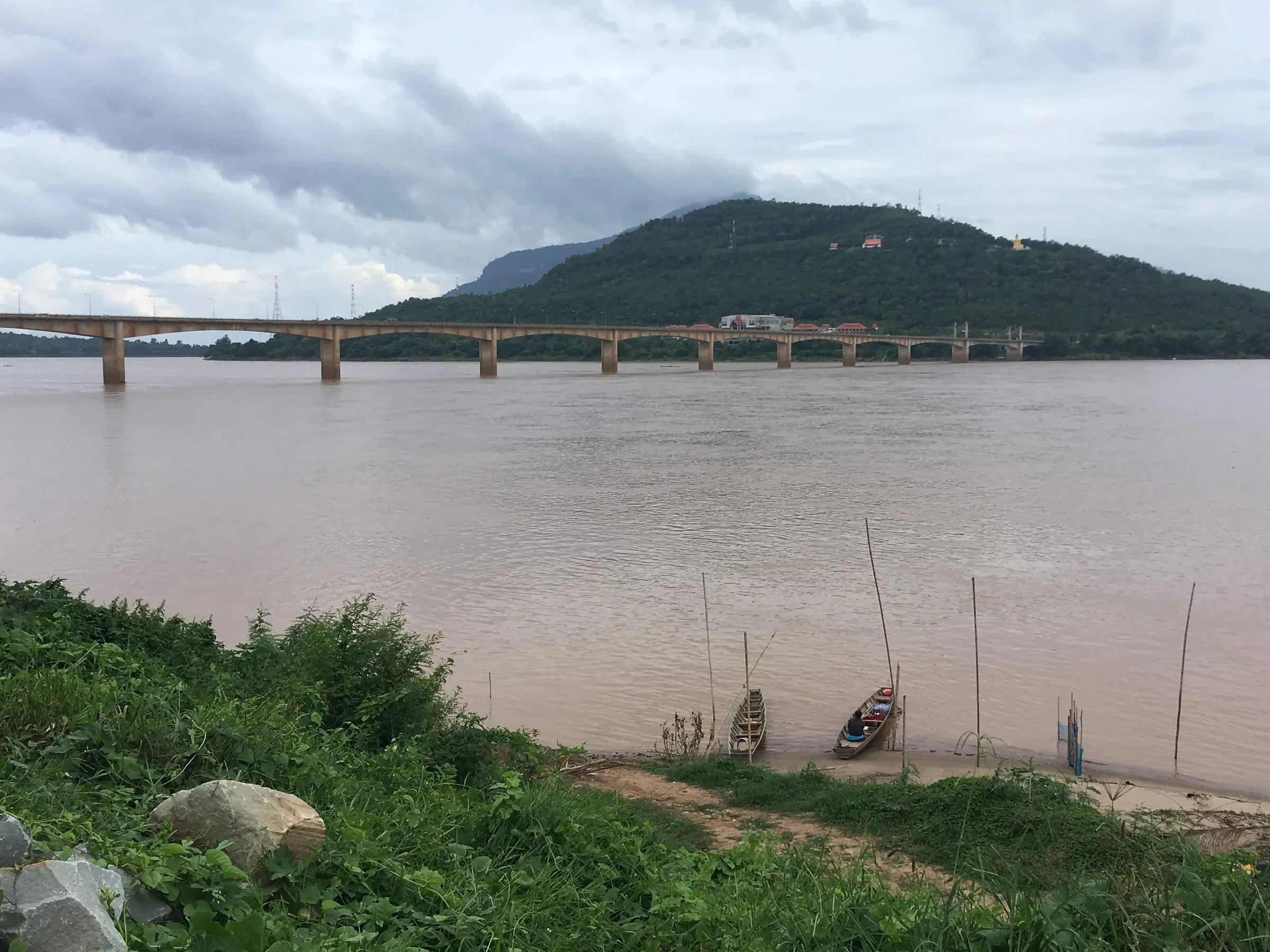 The bridge over the Mekong at Pakse, with a hill rising beyond