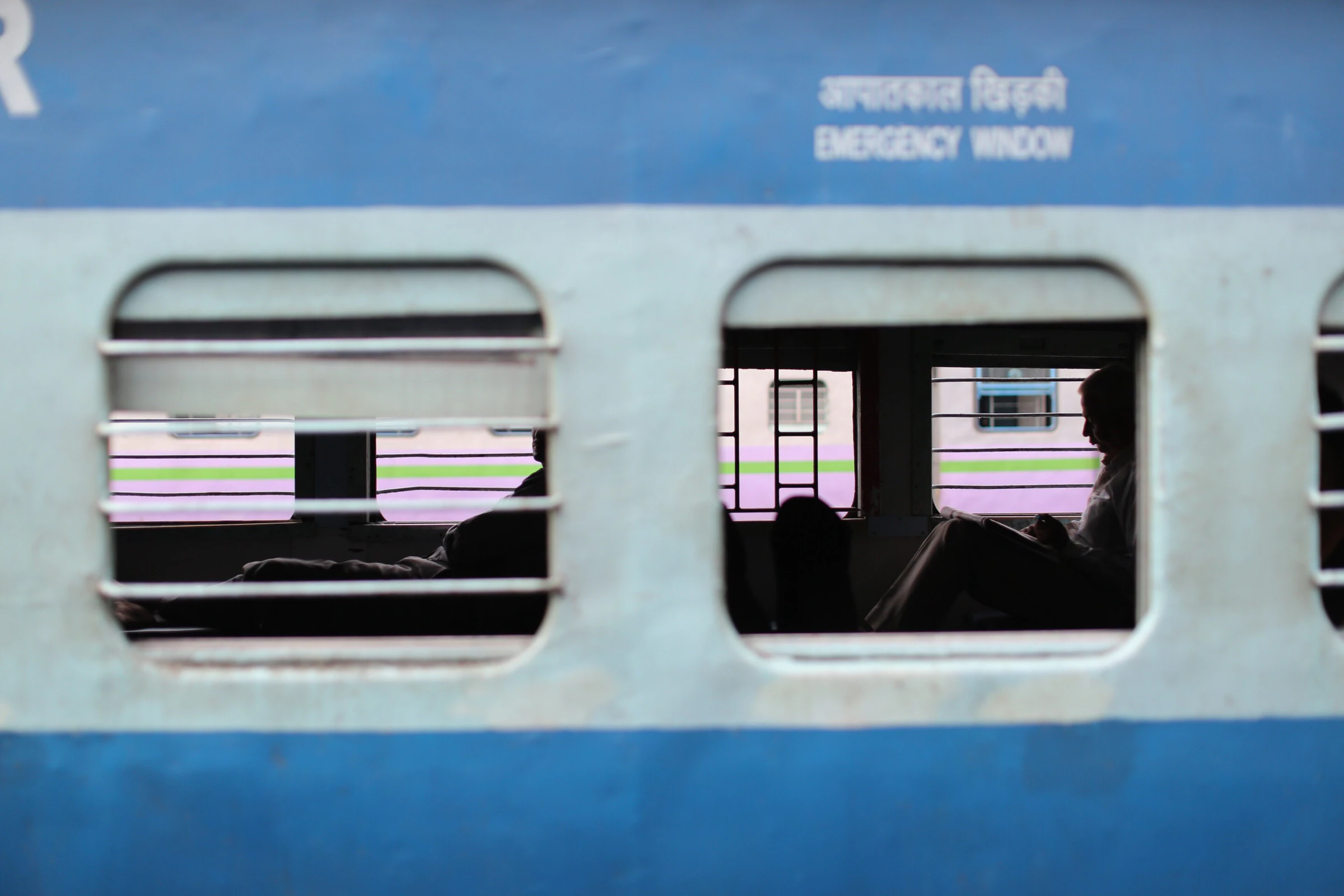The blue-and-white coach of an Indian sleeper train