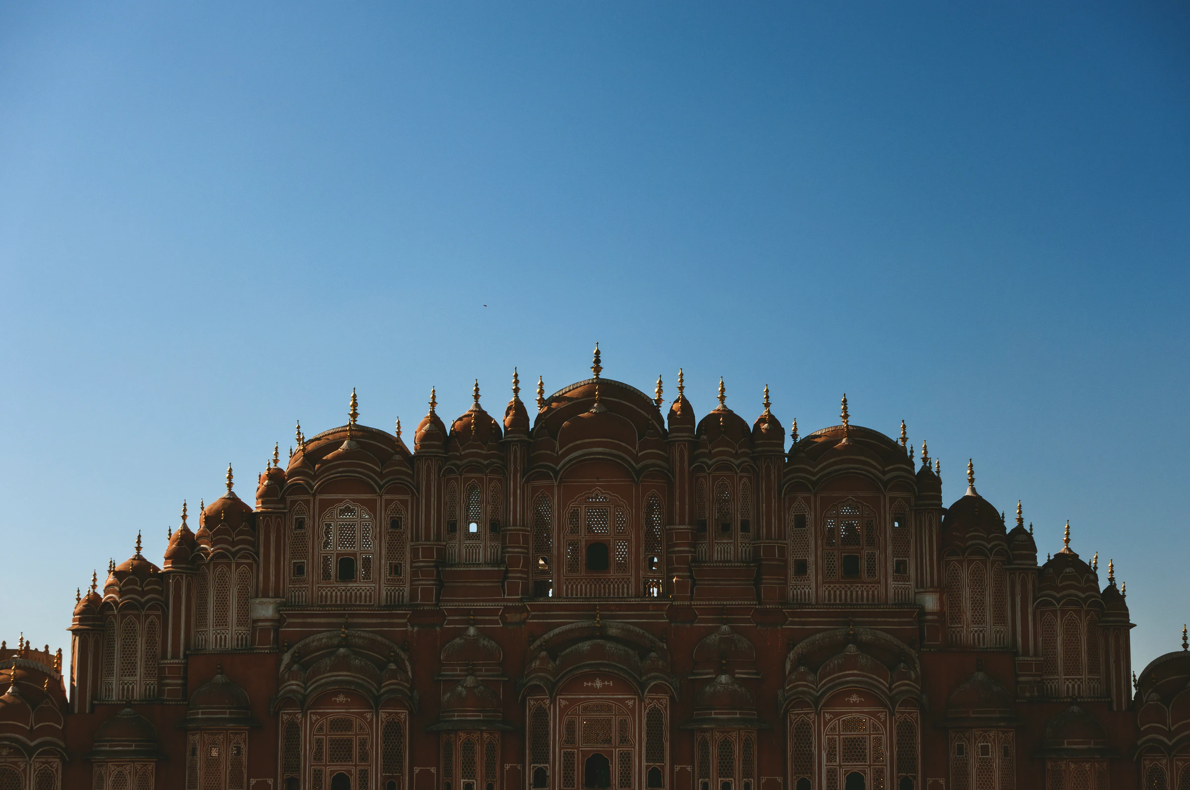 Hawa Mahal's carved facade in silhouette against an evening sky in Jaipur