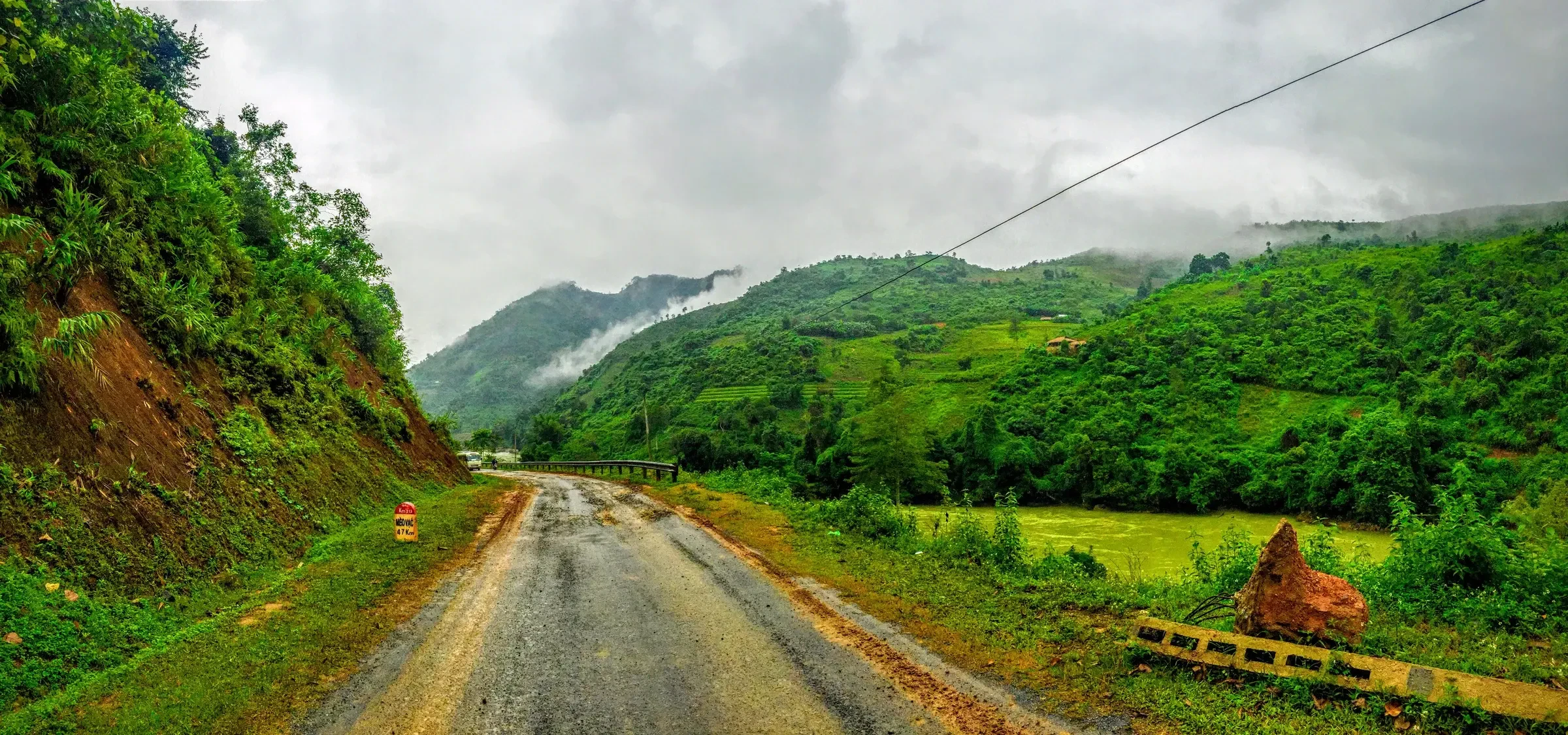 A mountain road through green hills near Bao Lac