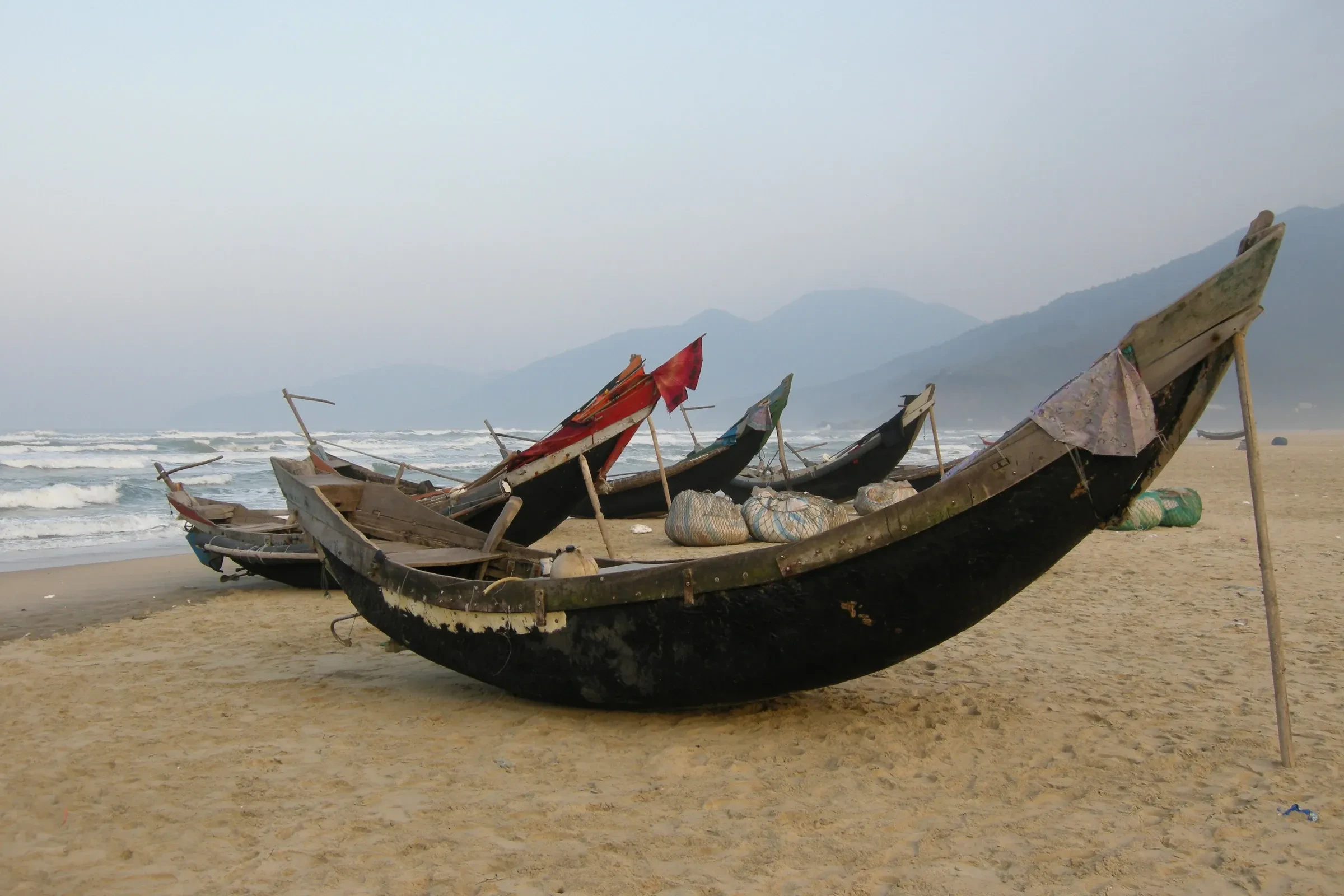Wooden fishing boats pulled up on Lang Co beach