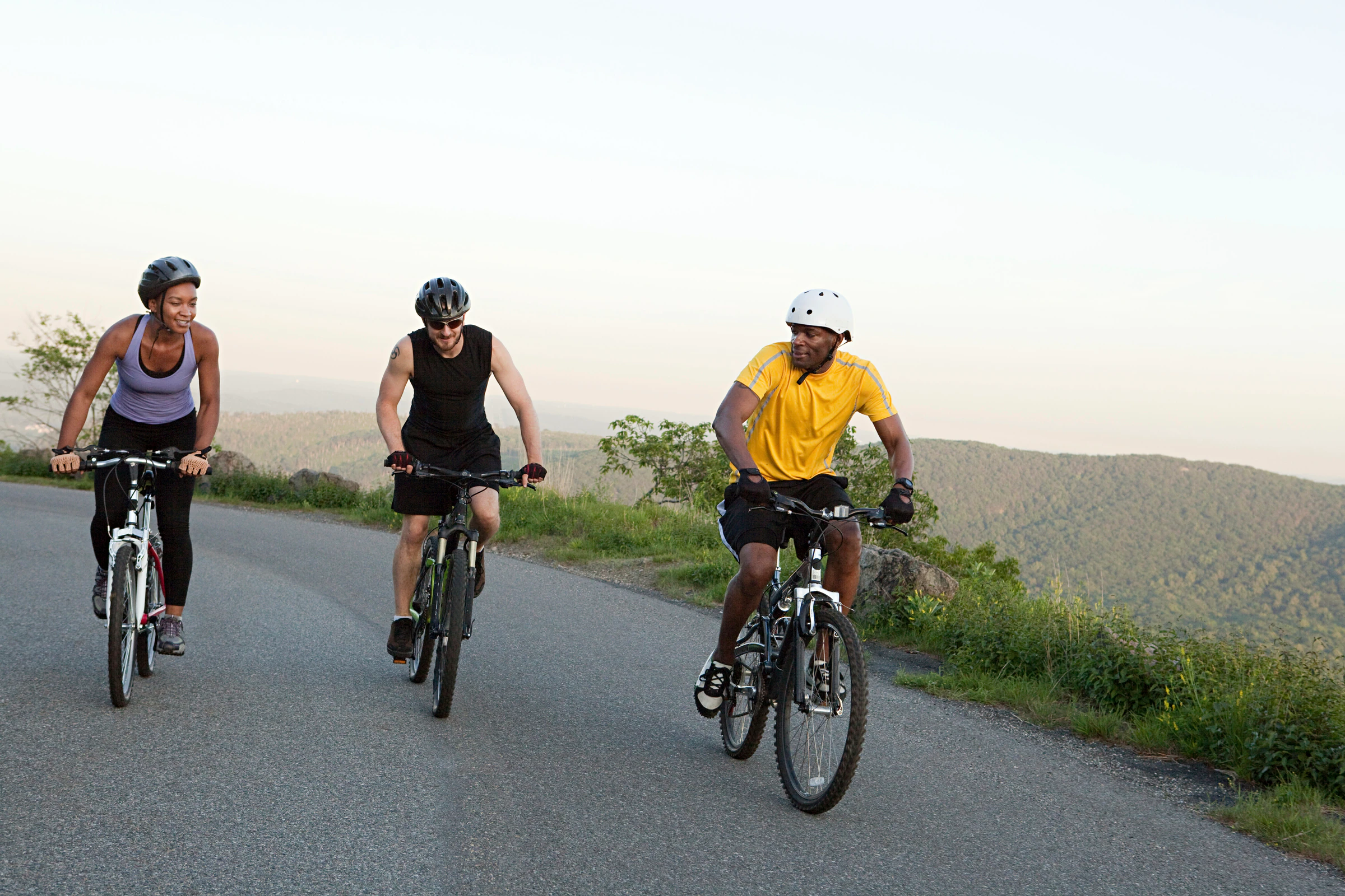 Three road cyclists riding together on an open road