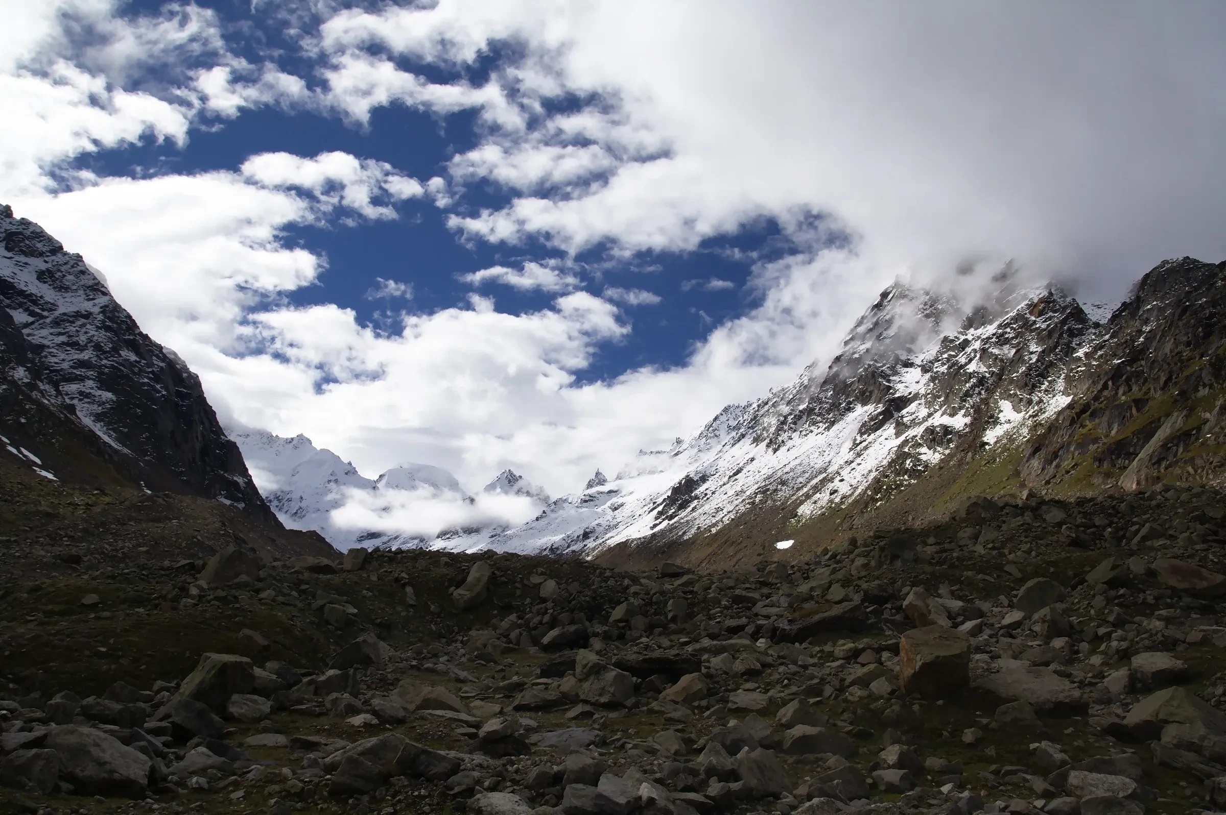 Snow slopes and cloud on the high ground near Hampta Pass