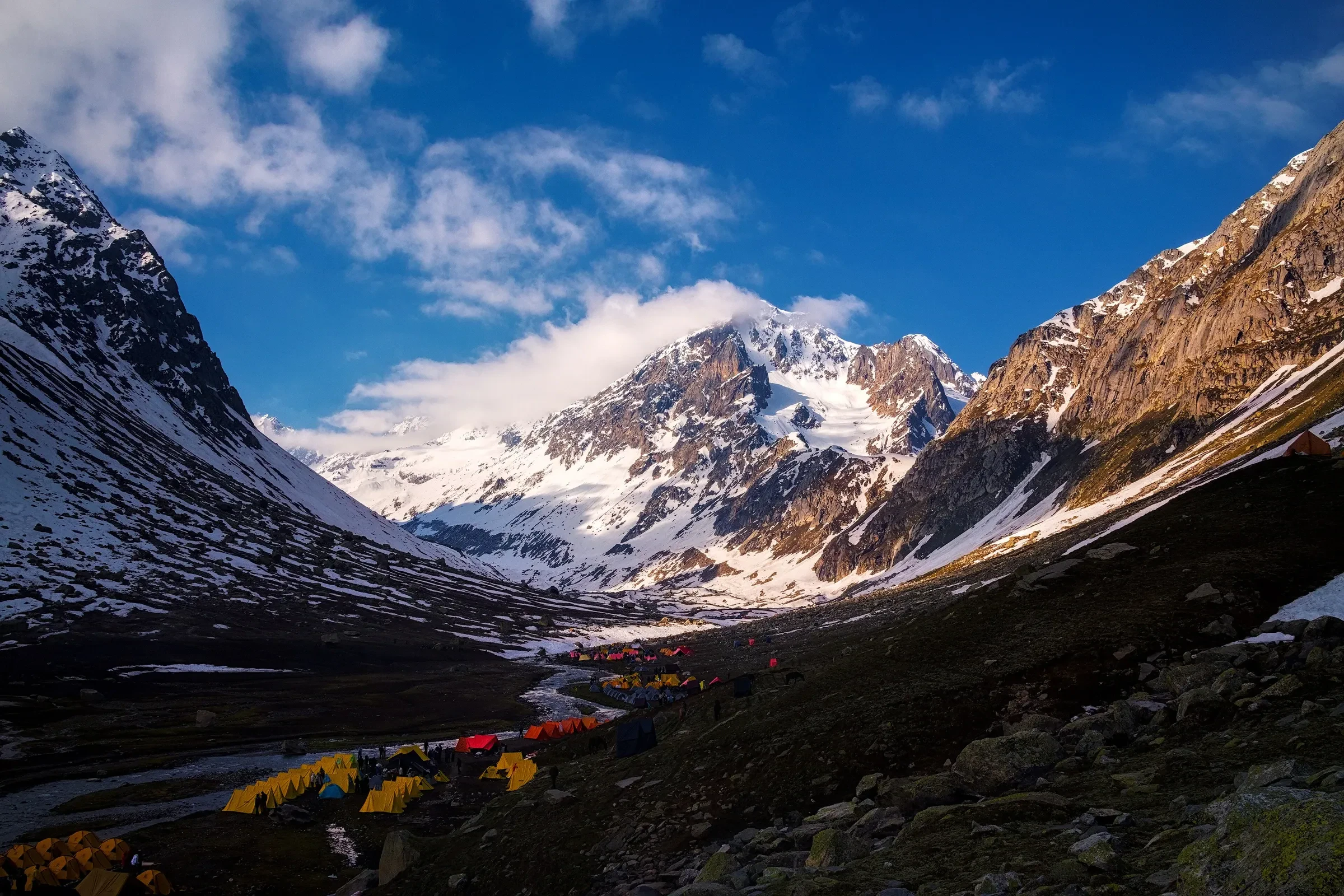 A camp in the valley at Shea Goru, below snow-covered peaks