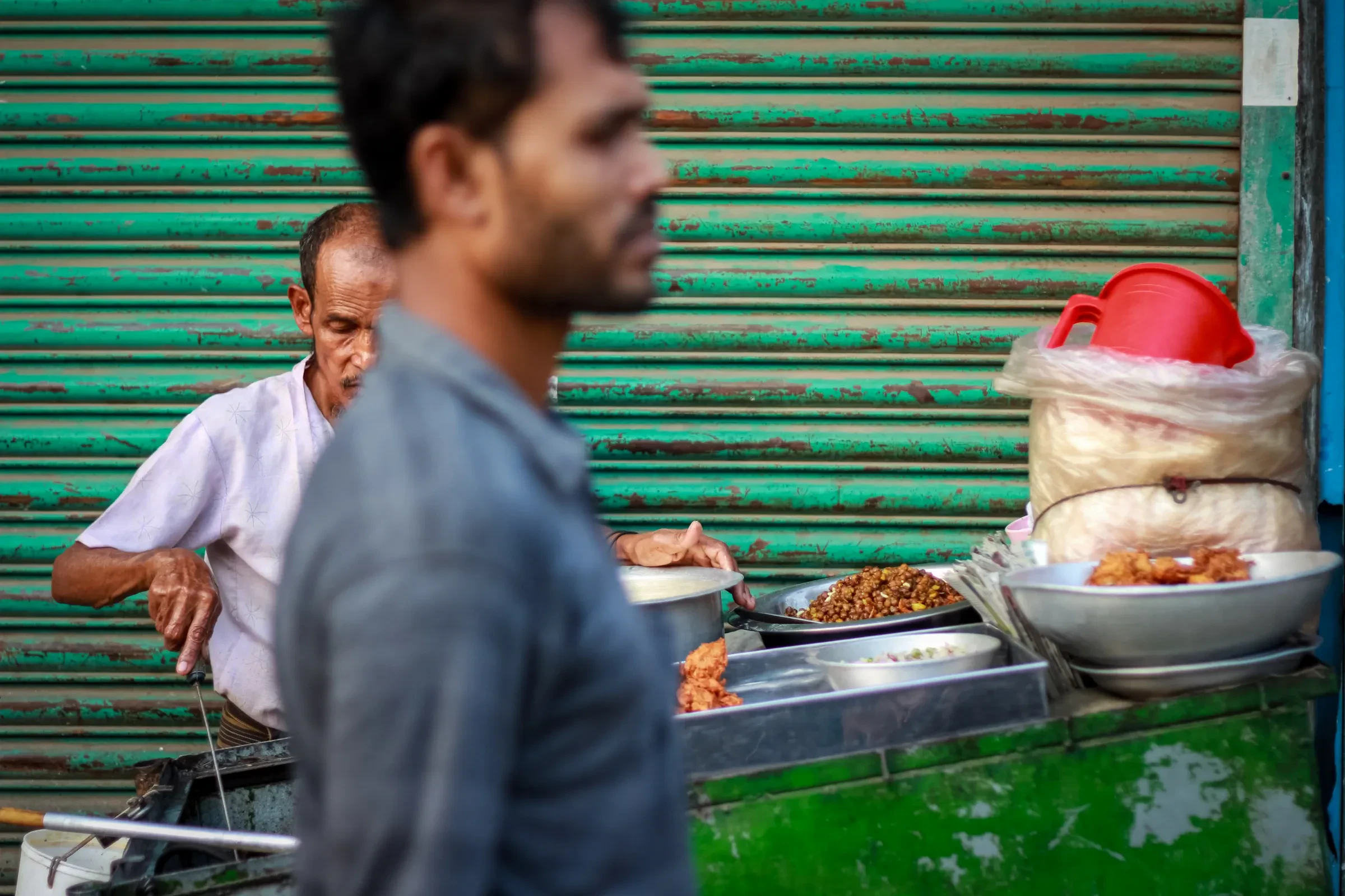 A busy street market stall in Delhi in the early evening