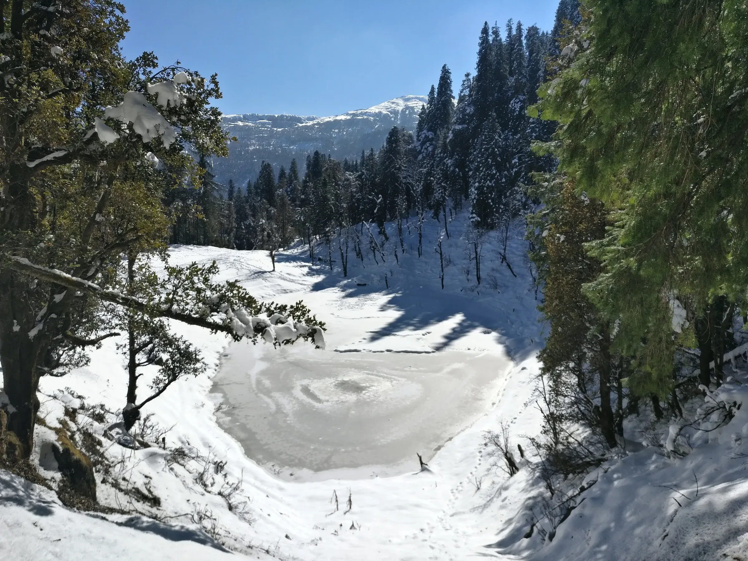 Juda Ka Talab, a frozen lake in a snowy bowl of pine forest