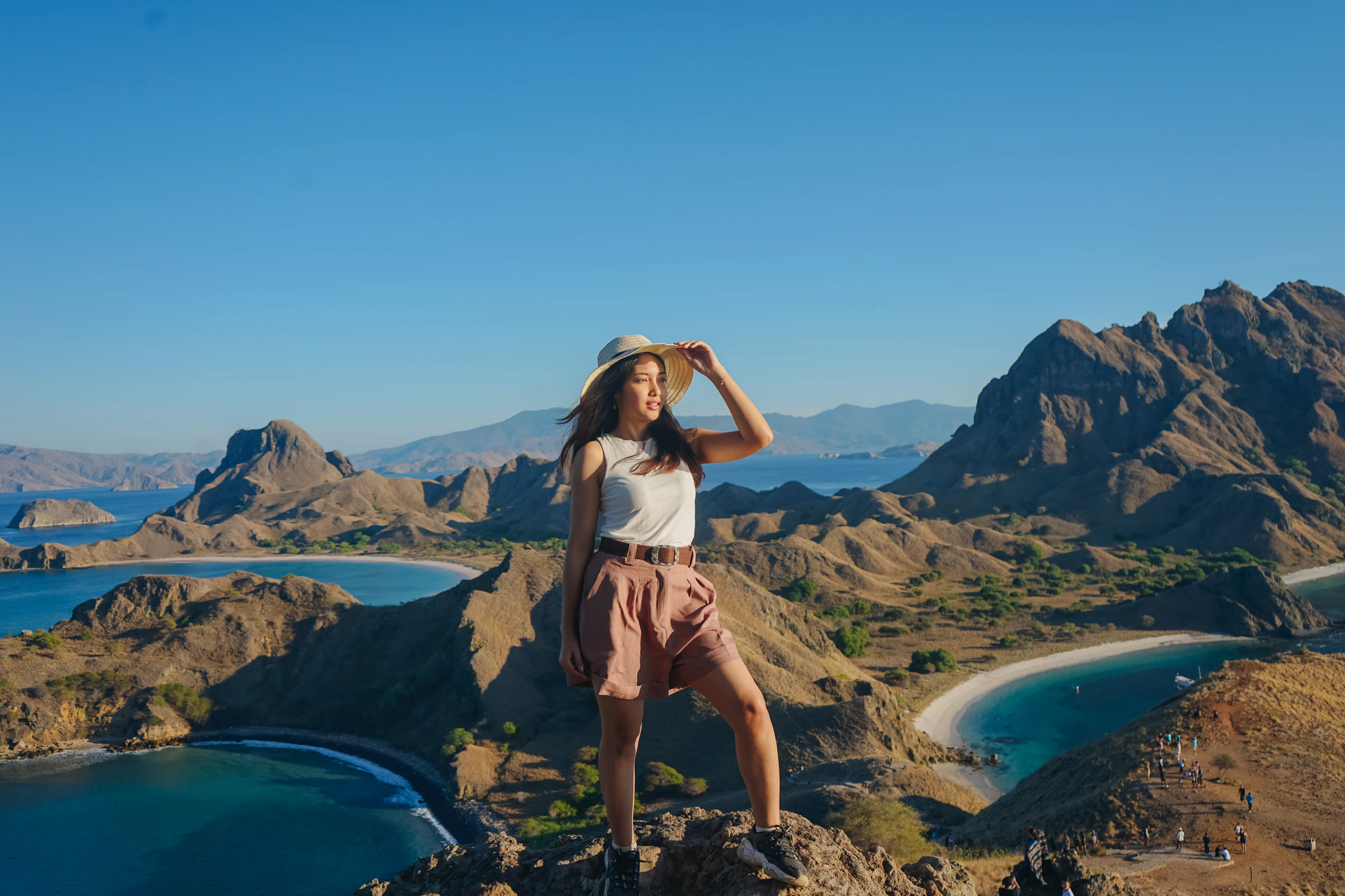 A traveller standing on a ridge at Padar island above its curved bays