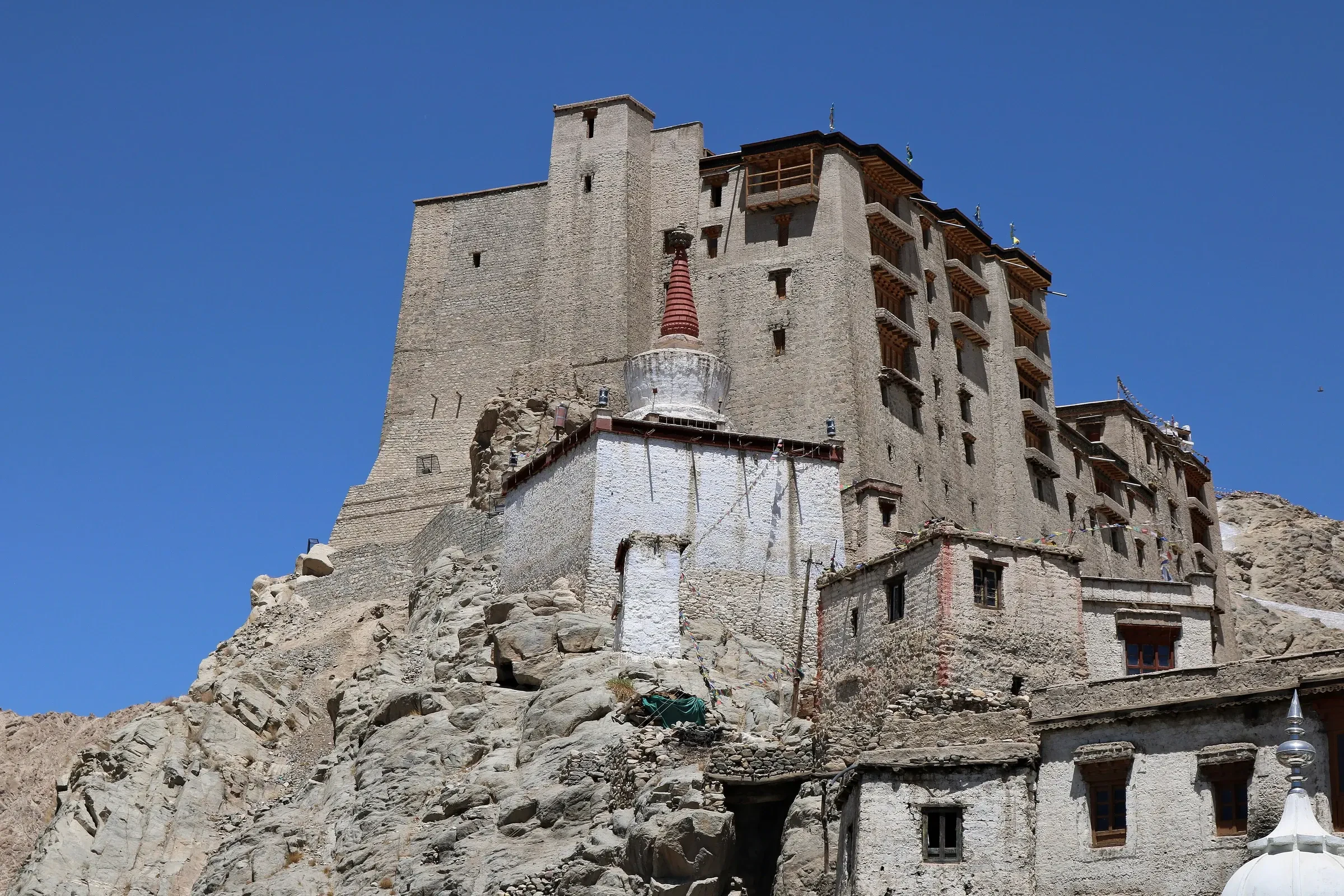 Leh Palace above the old town under a clear blue sky