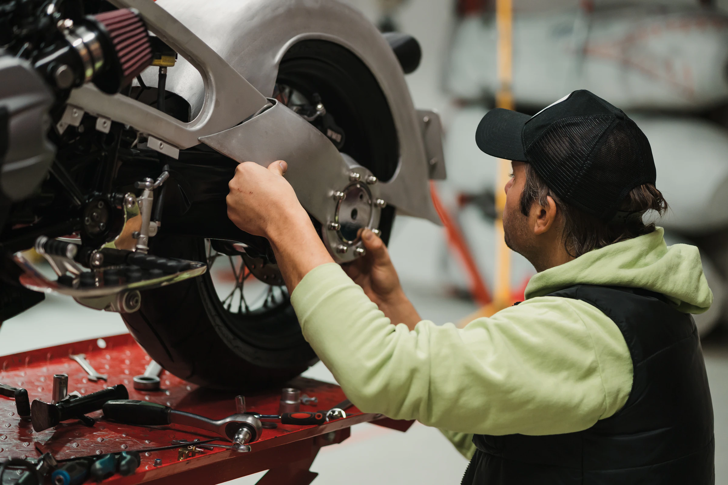 A mechanic checking over a motorbike before a high-altitude ride