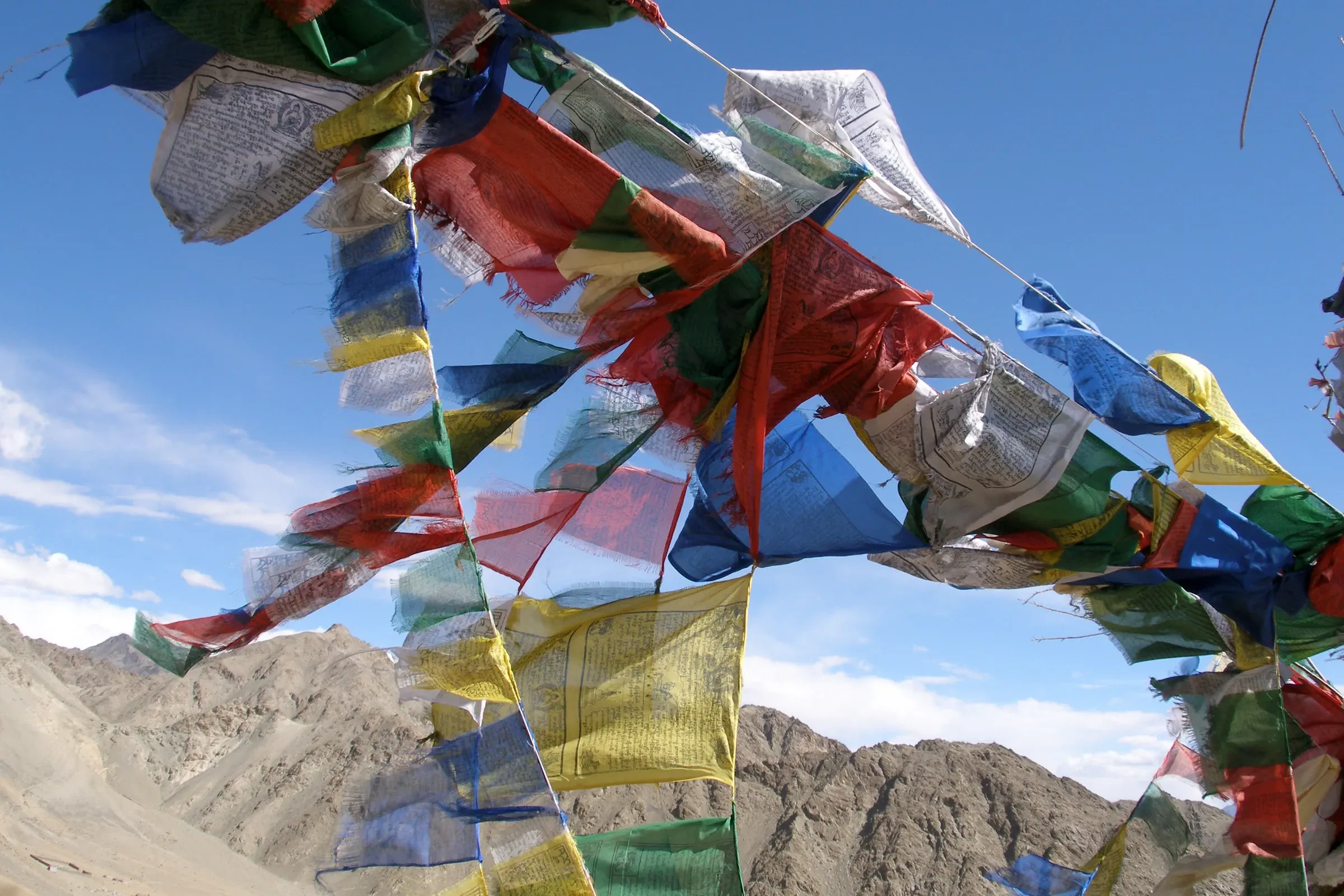 Tattered prayer flags above the mountains around Leh in Ladakh
