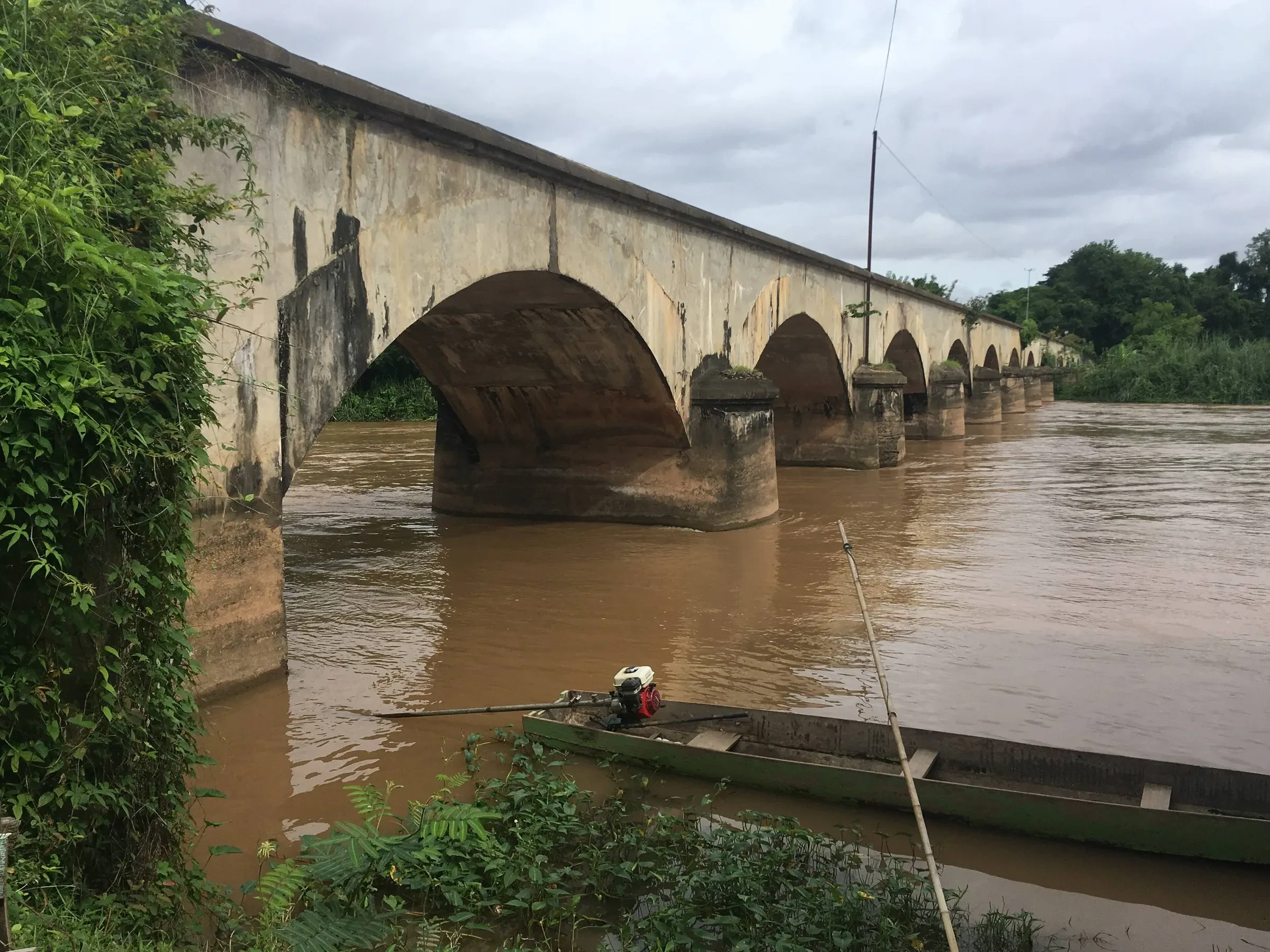The old stone railway bridge between Don Det and Don Khon over the brown Mekong